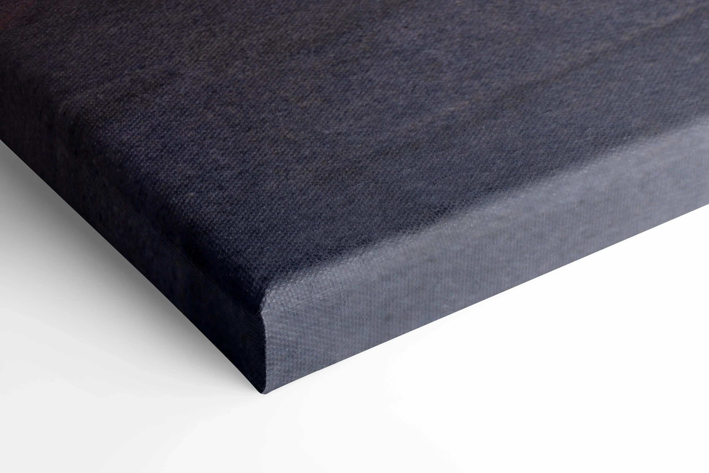 Close-up of black canvas art corner with textured surface, vertical wall art print with sharp edges.