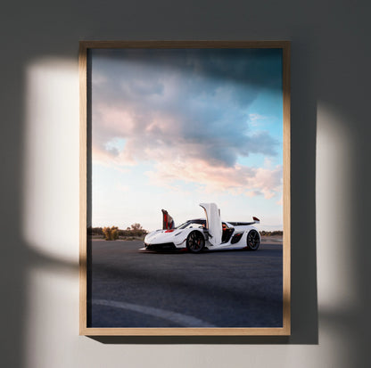 Koenigsegg Jesko white sports car parked on road under dramatic sky poster wall art in wooden frame.
