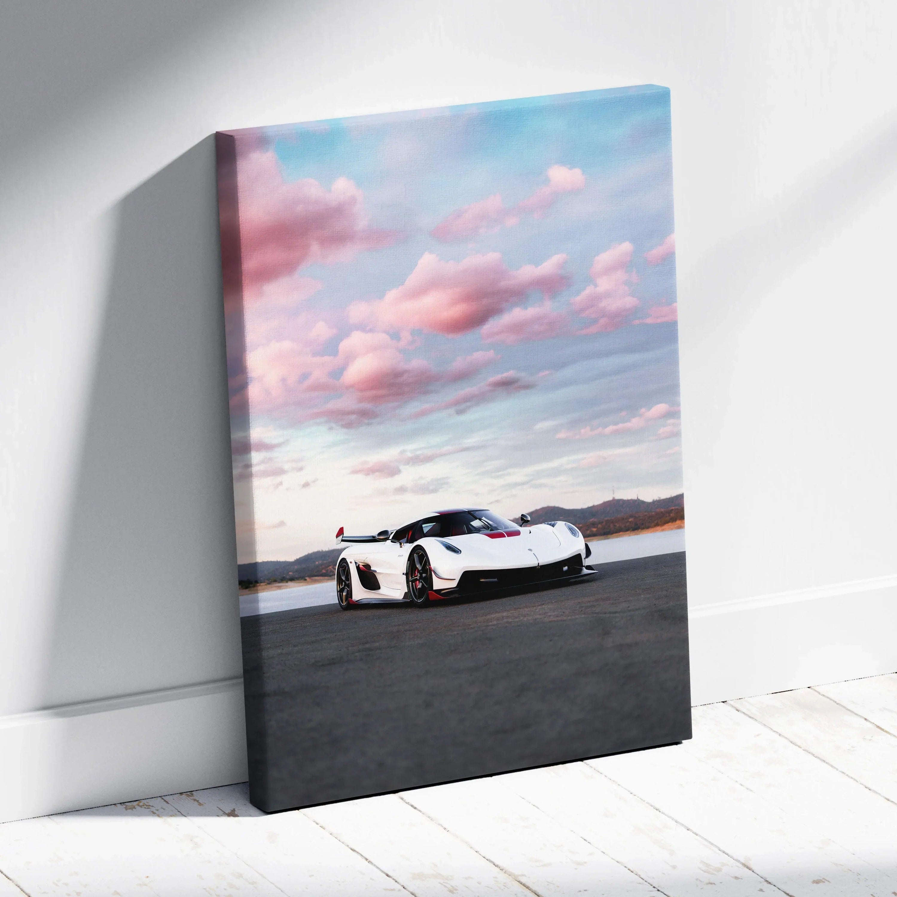 Koenigsegg Jesko sports car at sunset canvas wall art with pink clouds and mountains.