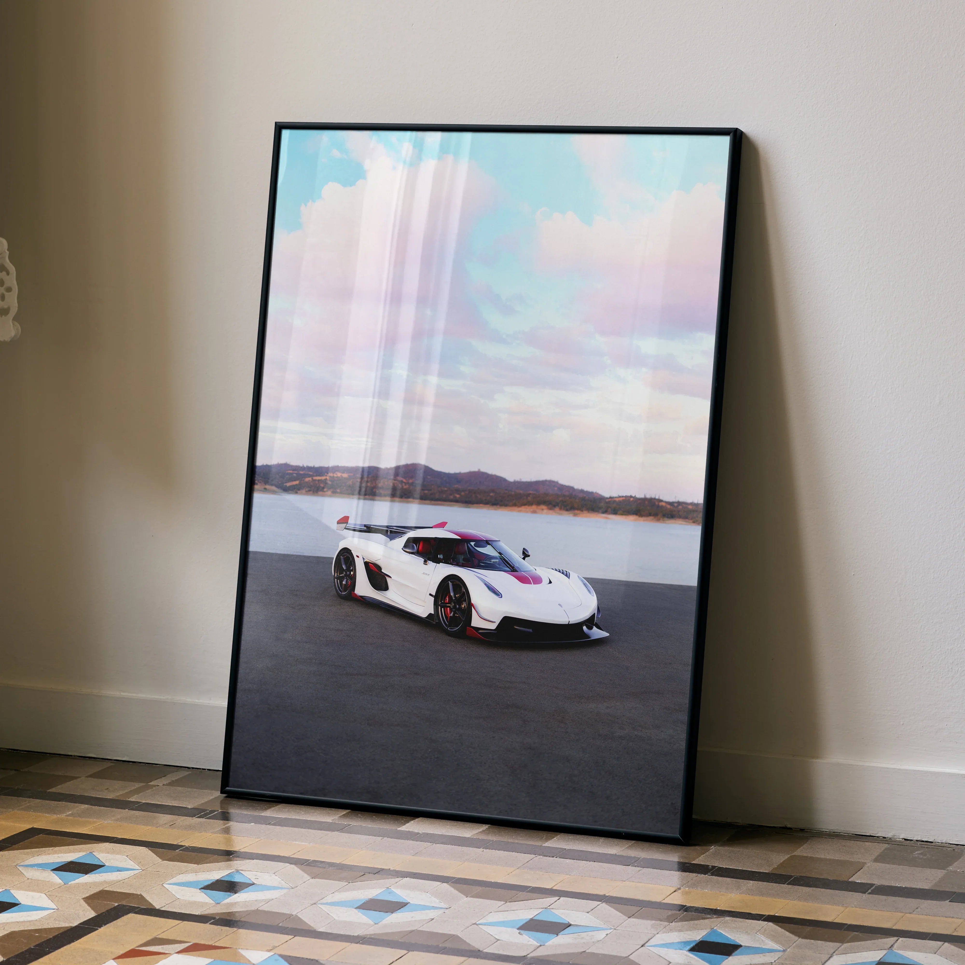 Koenigsegg Jesko poster featuring a white sports car on a road with blue sky, modern wall art.