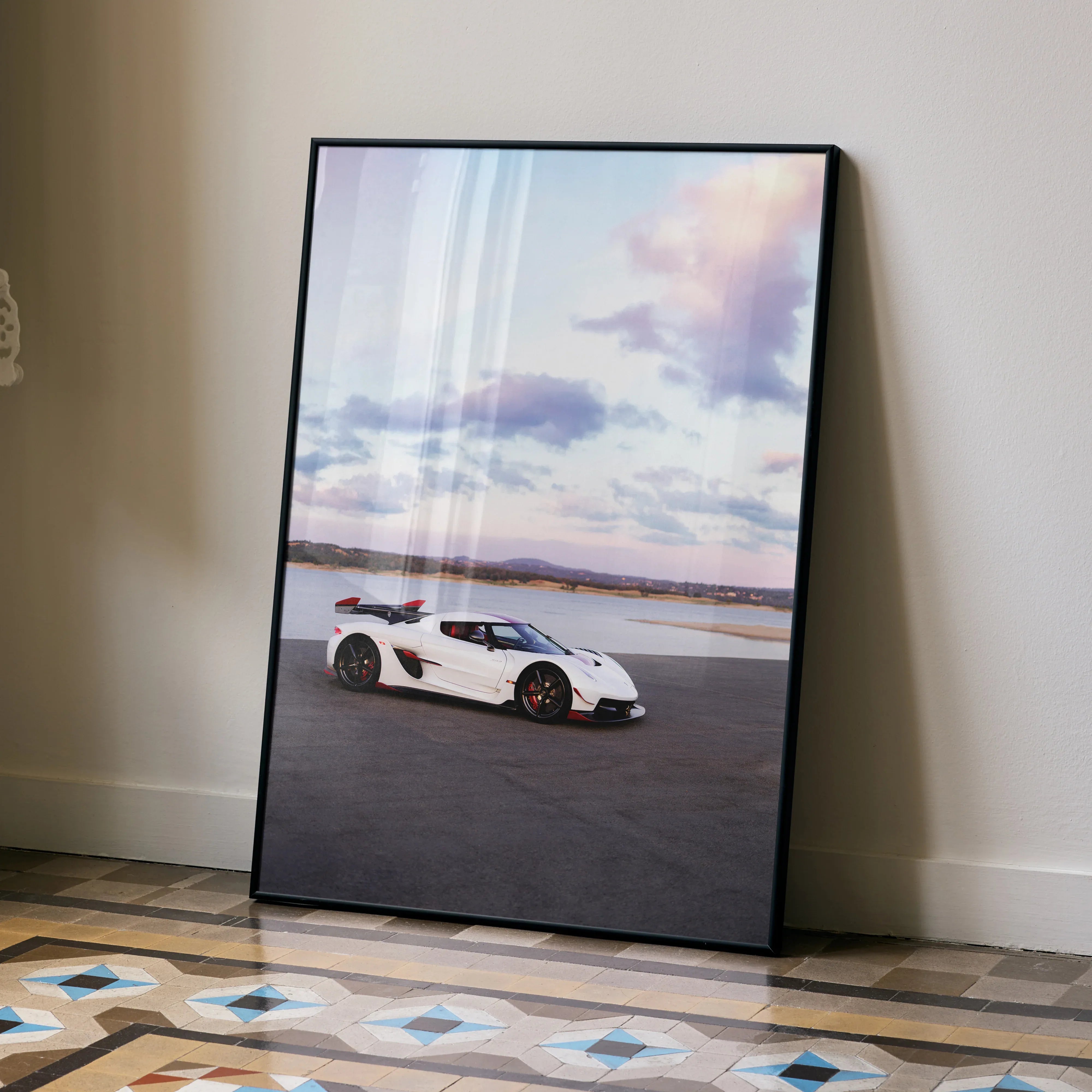 Koenigsegg Jesko white sports car poster leaning against wall with scenic sky background wall art.