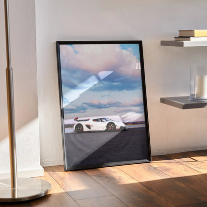 Koenigsegg Jesko white sports car poster wall art in black frame leaning on floor.