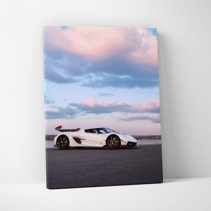 Vertical canvas wall art featuring a white Koenigsegg Jesko sports car under a pink and blue sky.