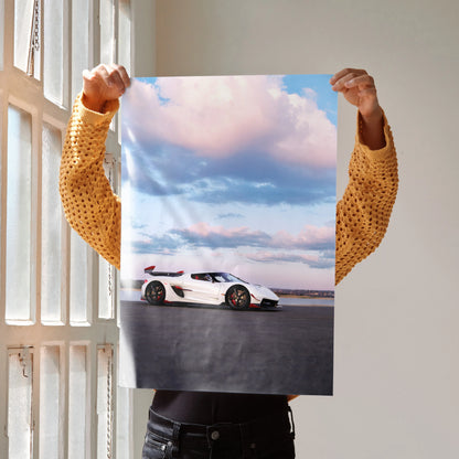 Koenigsegg Jesko car poster showing white sports car under blue sky with clouds, wall art.