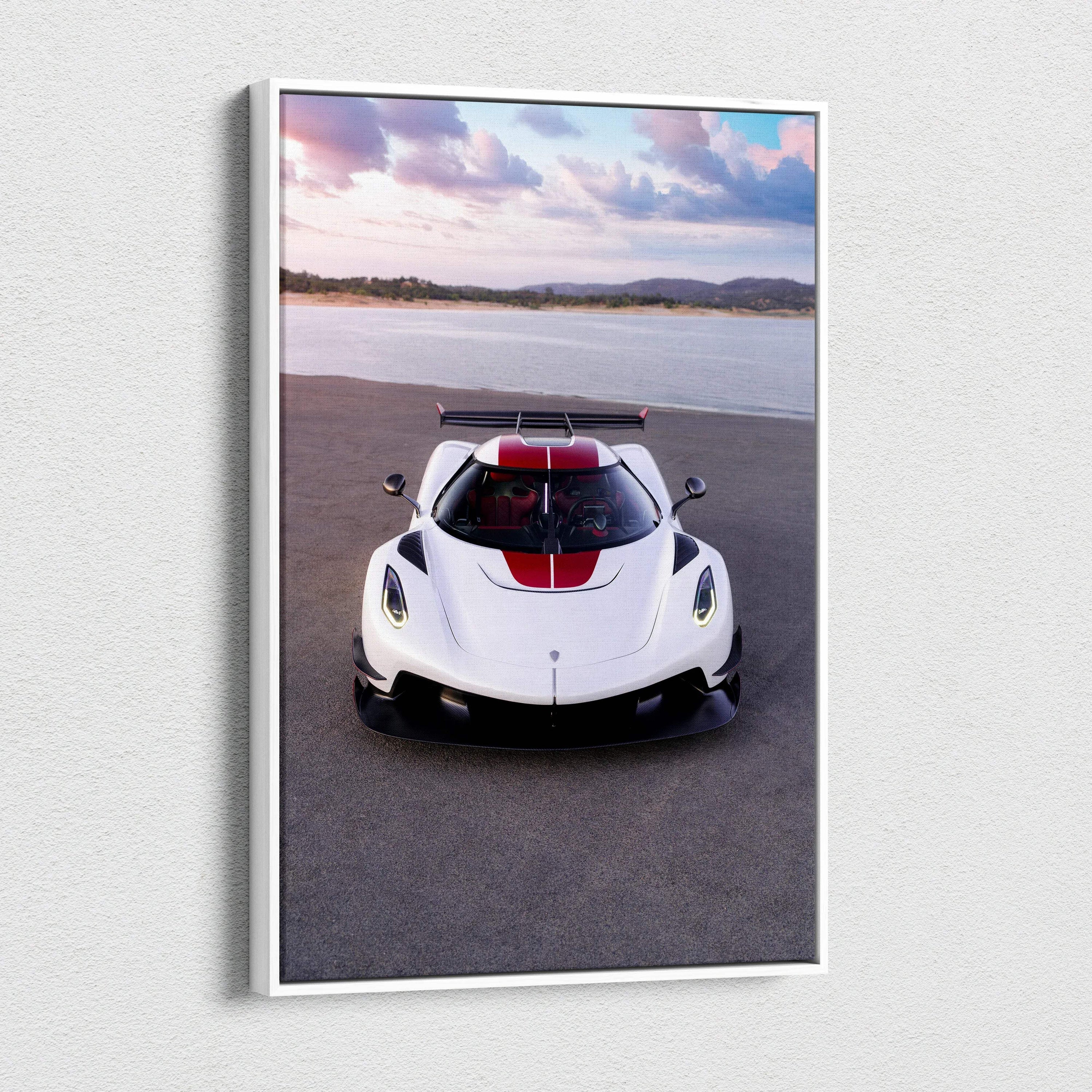 Vertical Koenigsegg Jesko canvas art showing white sports car with red stripe on asphalt by water and hills wall art.