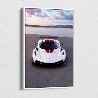 Vertical Koenigsegg Jesko canvas art showing white sports car with red stripe on asphalt by water and hills wall art.
