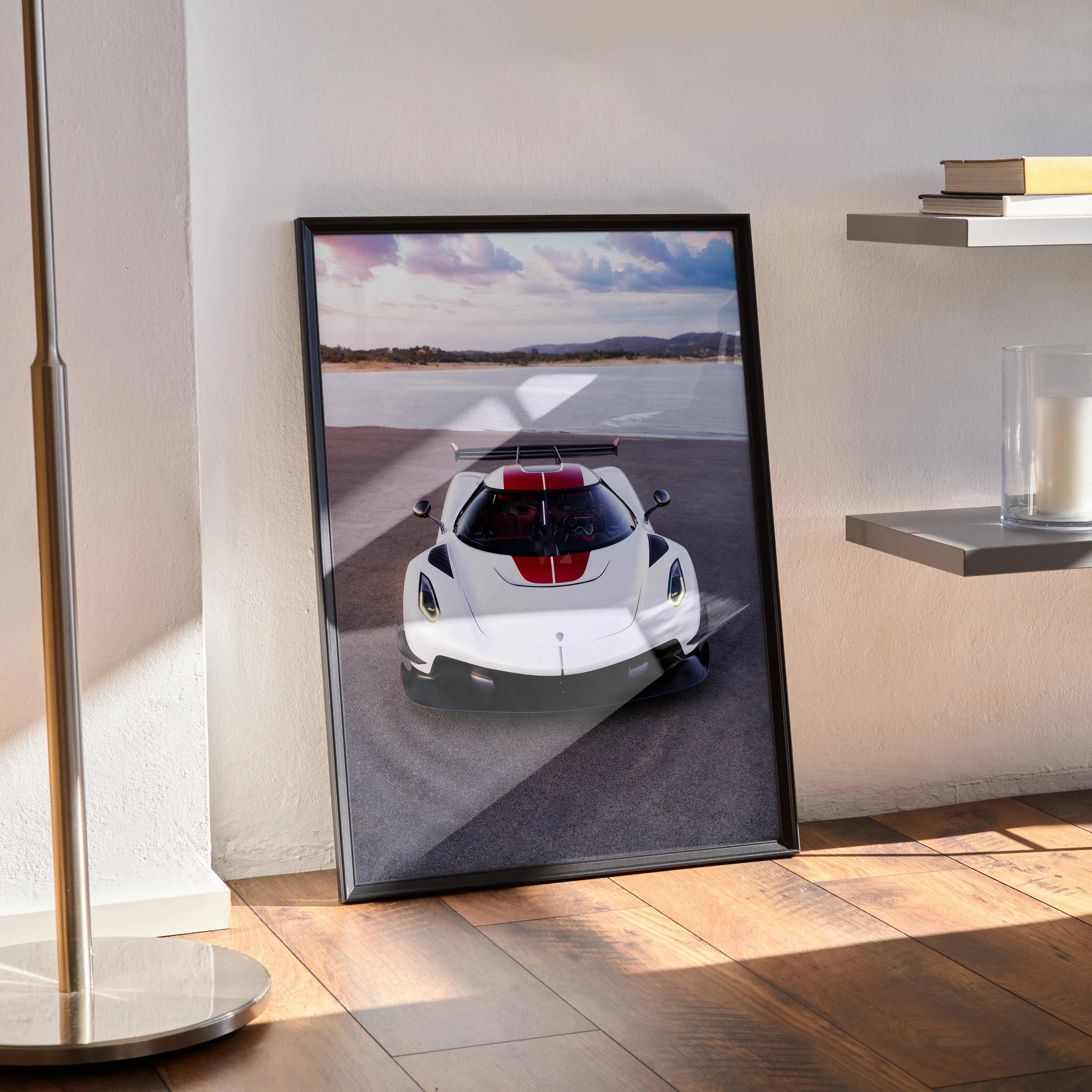 Koenigsegg Jesko car poster wall art in black frame, featuring white sports car on road under blue sky.
