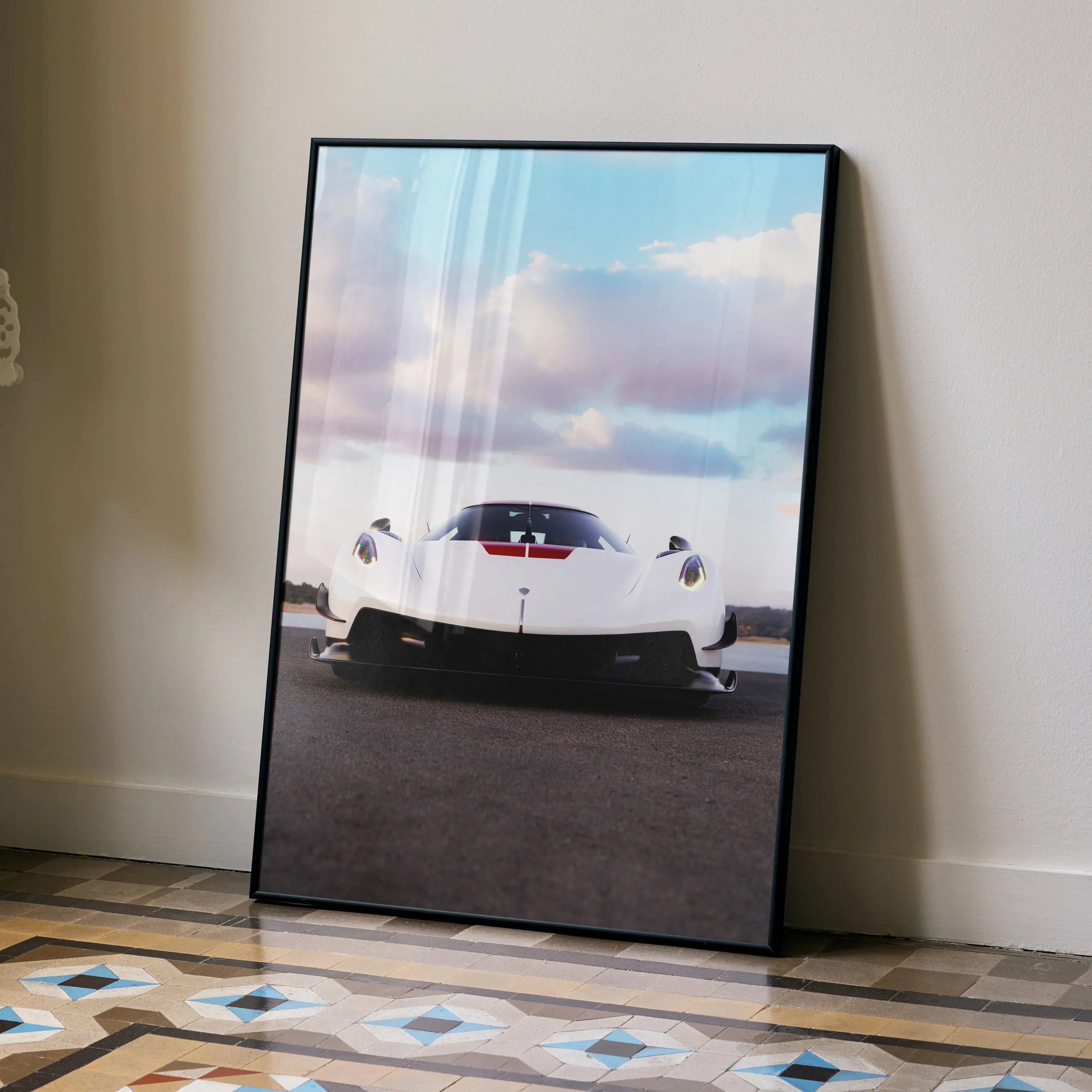 Koenigsegg Jesko white sports car poster with black frame leaning against wall wall art.