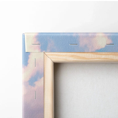 Close-up of wooden frame corner and canvas texture with sky-themed wall art print.