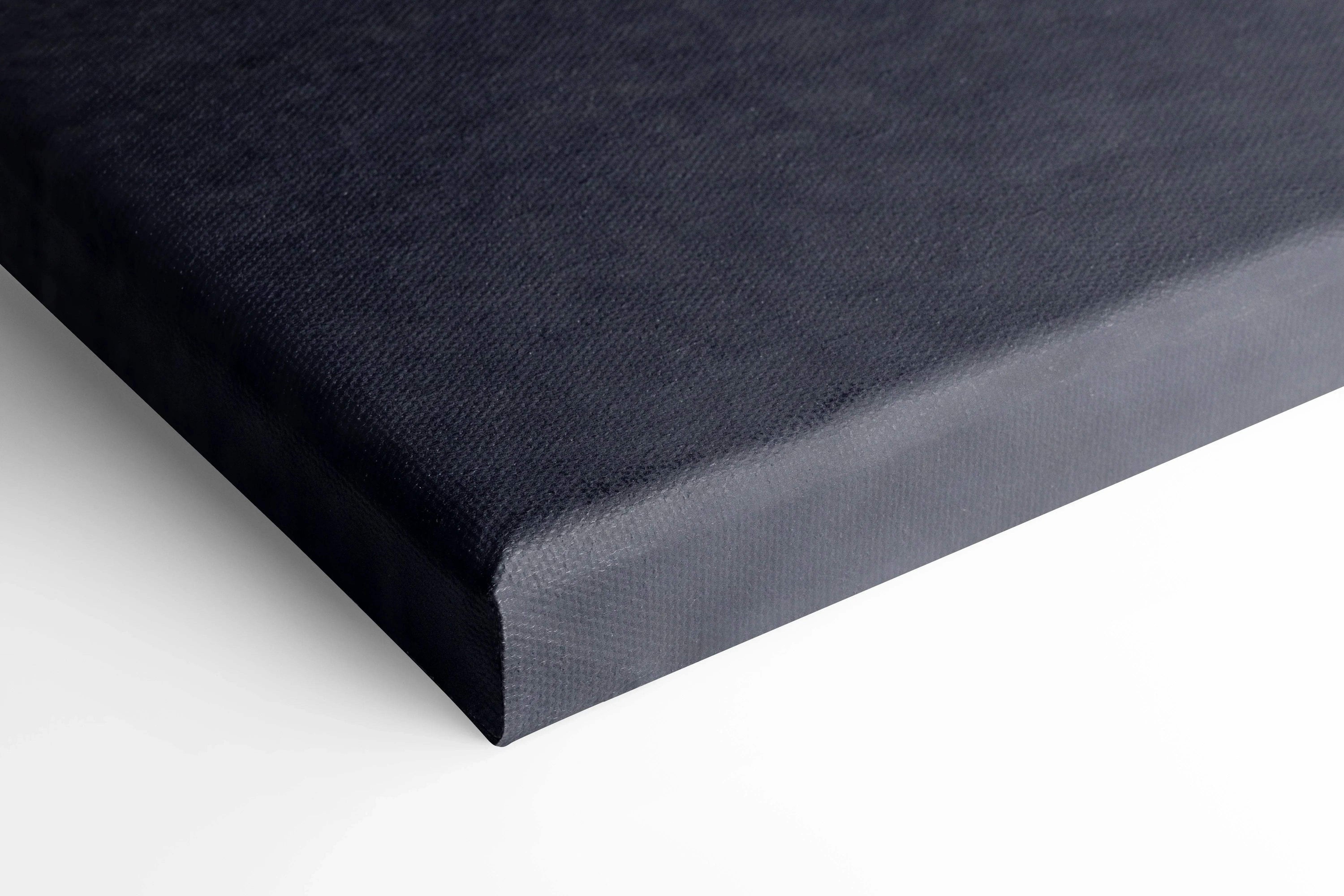 Close-up of black canvas wall art corner with smooth texture and clean wrapped edges.