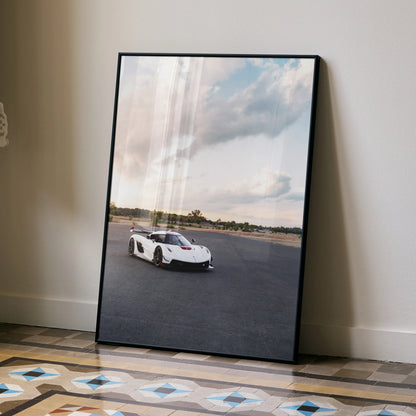 Koenigsegg Jesko poster wall art featuring white sports car on racetrack under cloudy sky.