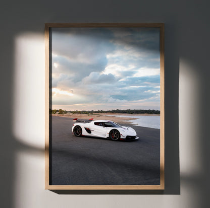 Koenigsegg Jesko car poster wall art with white supercar on racetrack under cloudy sky.