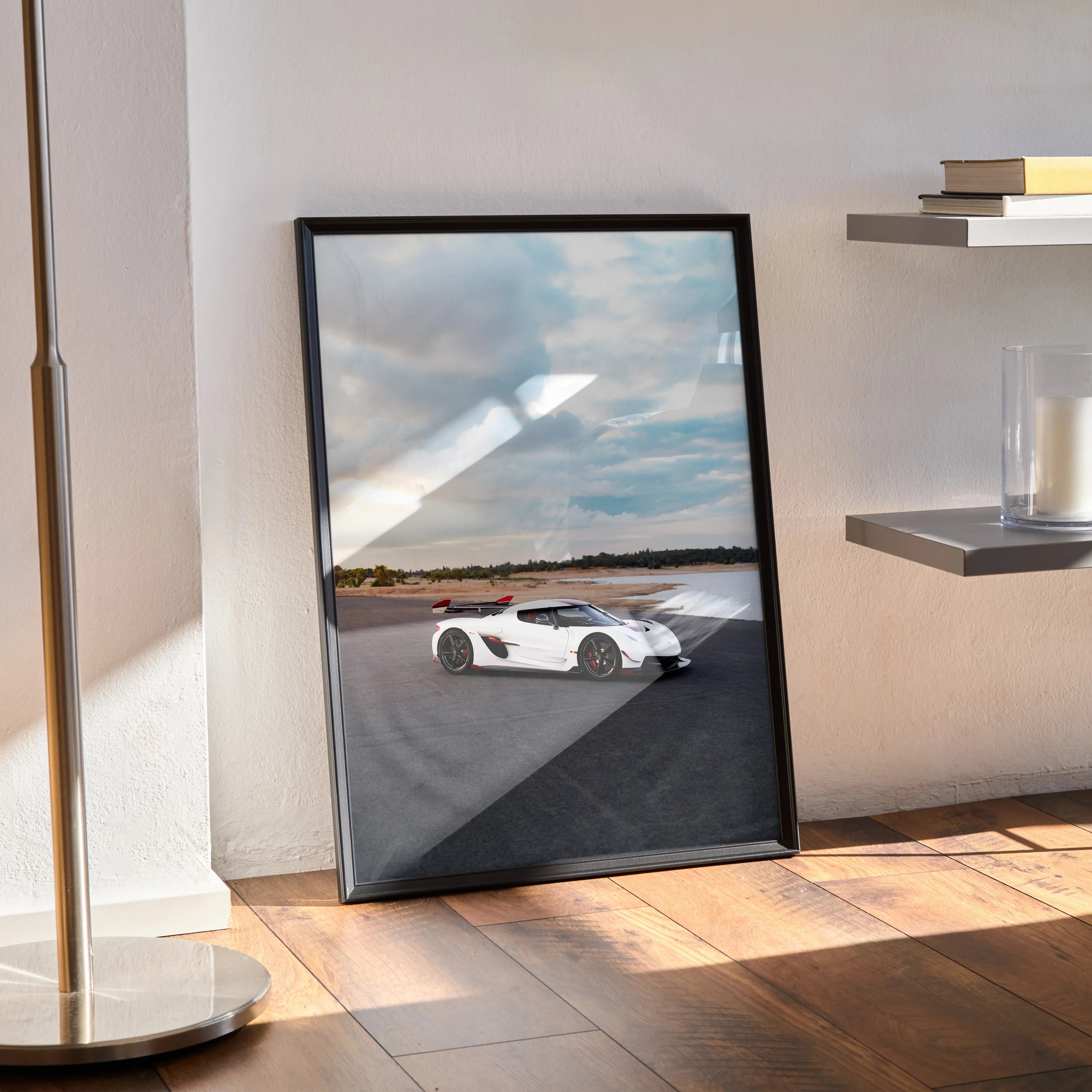 Koenigsegg Jesko white sports car poster leaning on floor as modern wall art with black frame.
