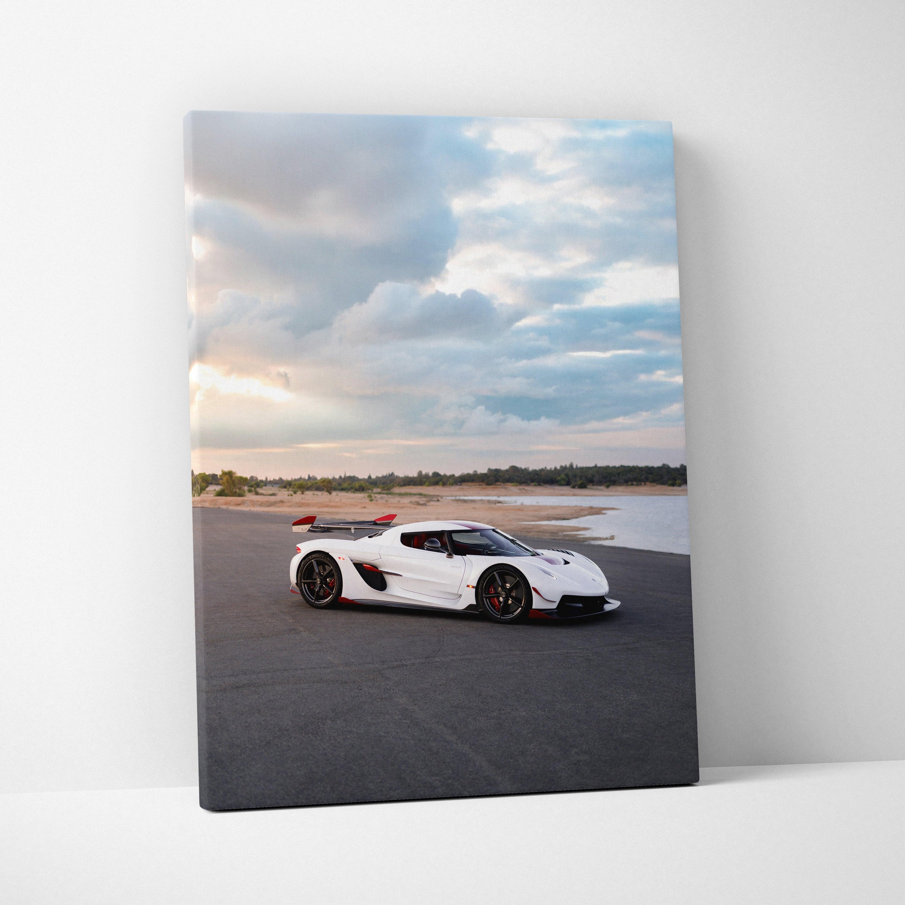 White Koenigsegg Jesko sports car on racetrack canvas art with cloudy sky wall art.