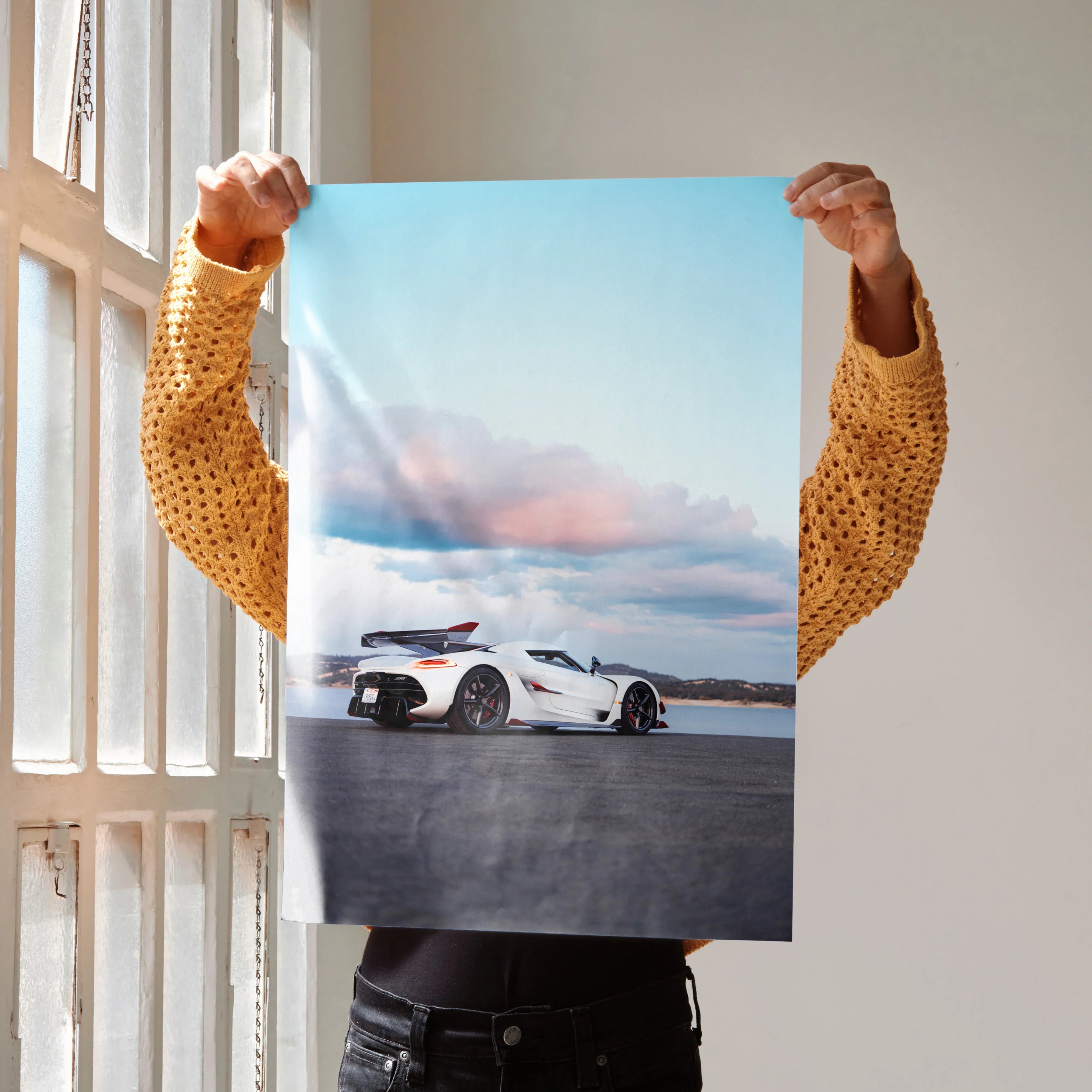 Koenigsegg Jesko poster featuring white sports car on open road under blue sky wall art.