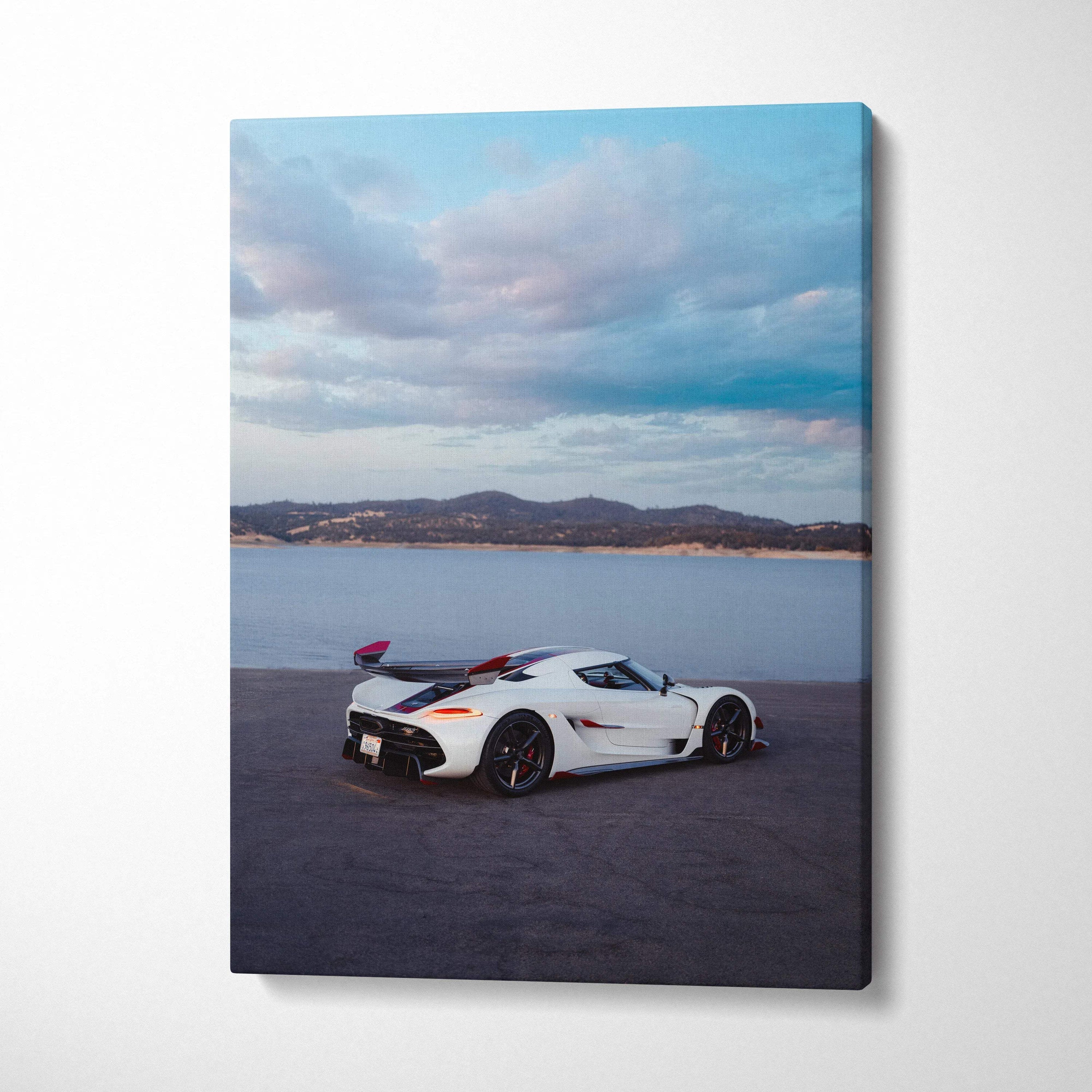 Koenigsegg Jesko sports car parked near water under cloudy sky on vertical canvas wall art.