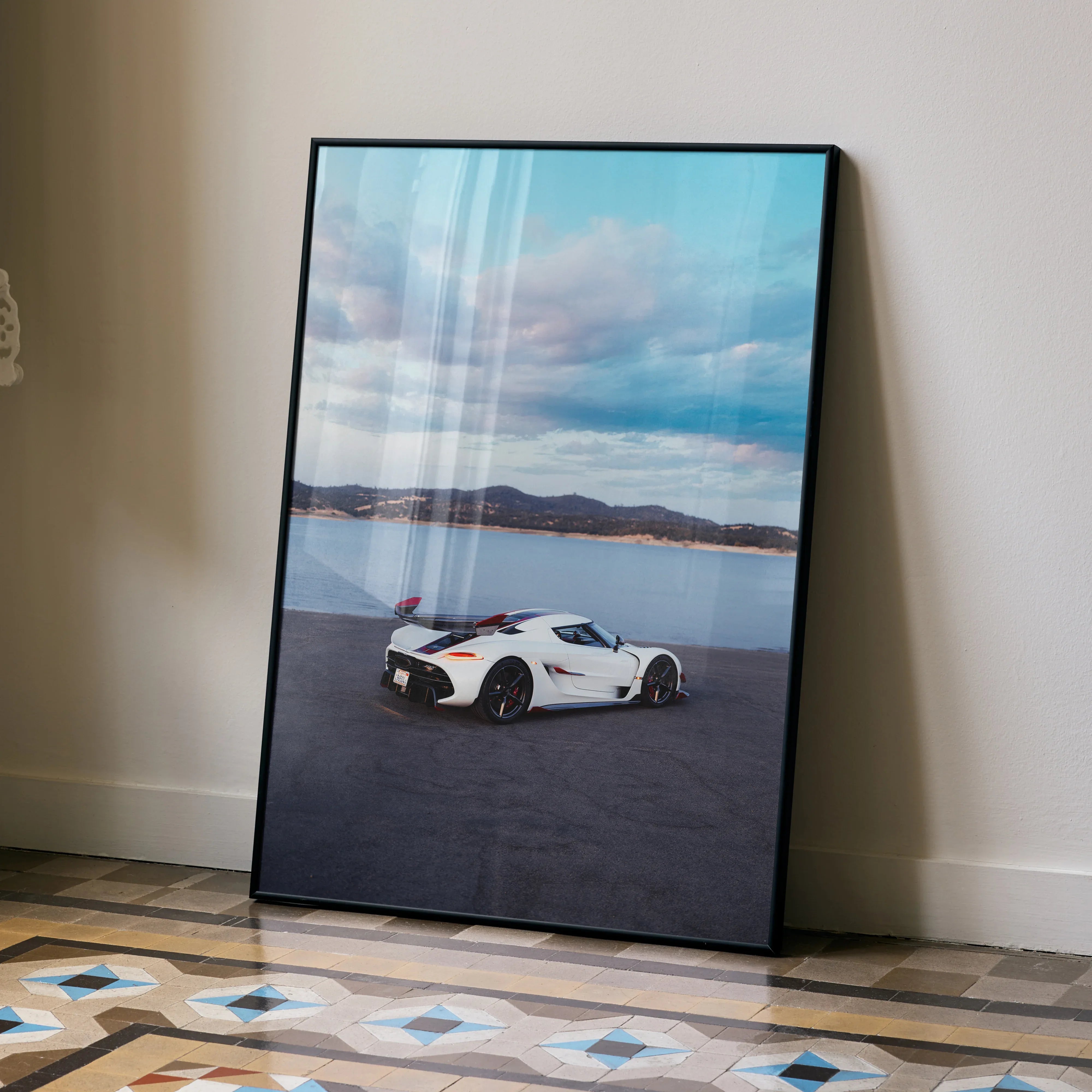 Koenigsegg Jesko white sports car poster with mountain and sky background wall art.