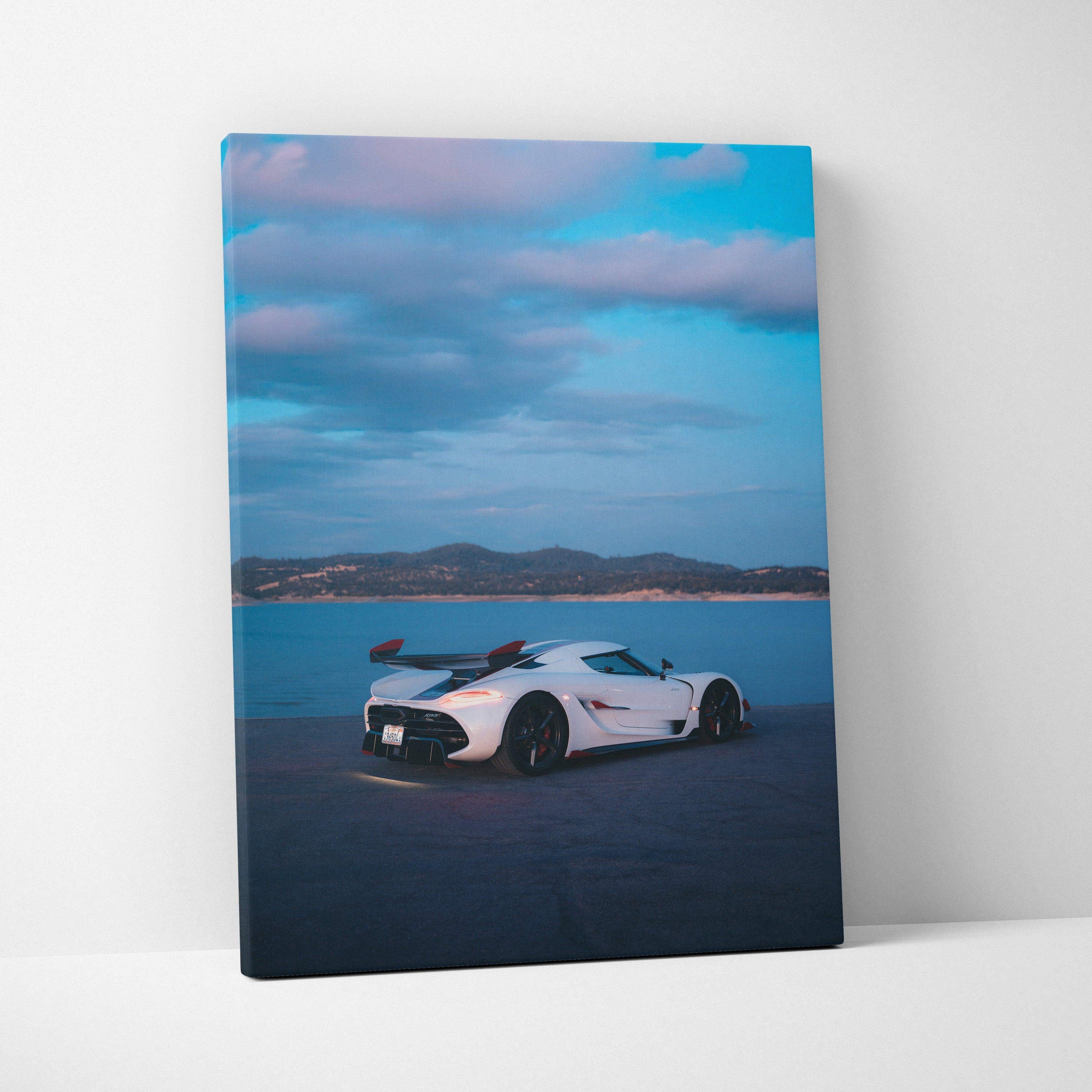 White Koenigsegg Jesko car parked by water under blue cloudy sky on vertical canvas wall art.