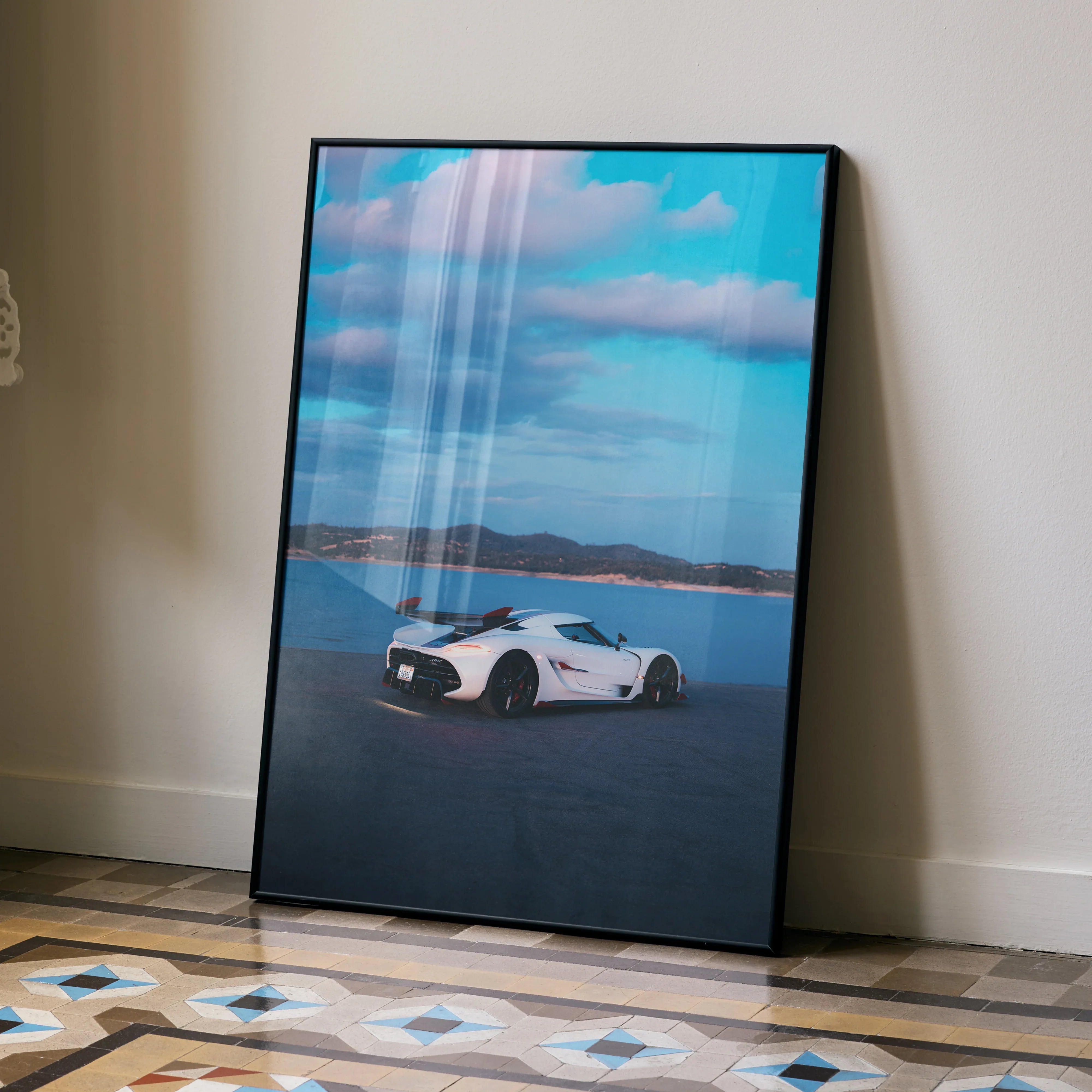 Koenigsegg Jesko car poster with white sports car on lake and blue sky wall art.