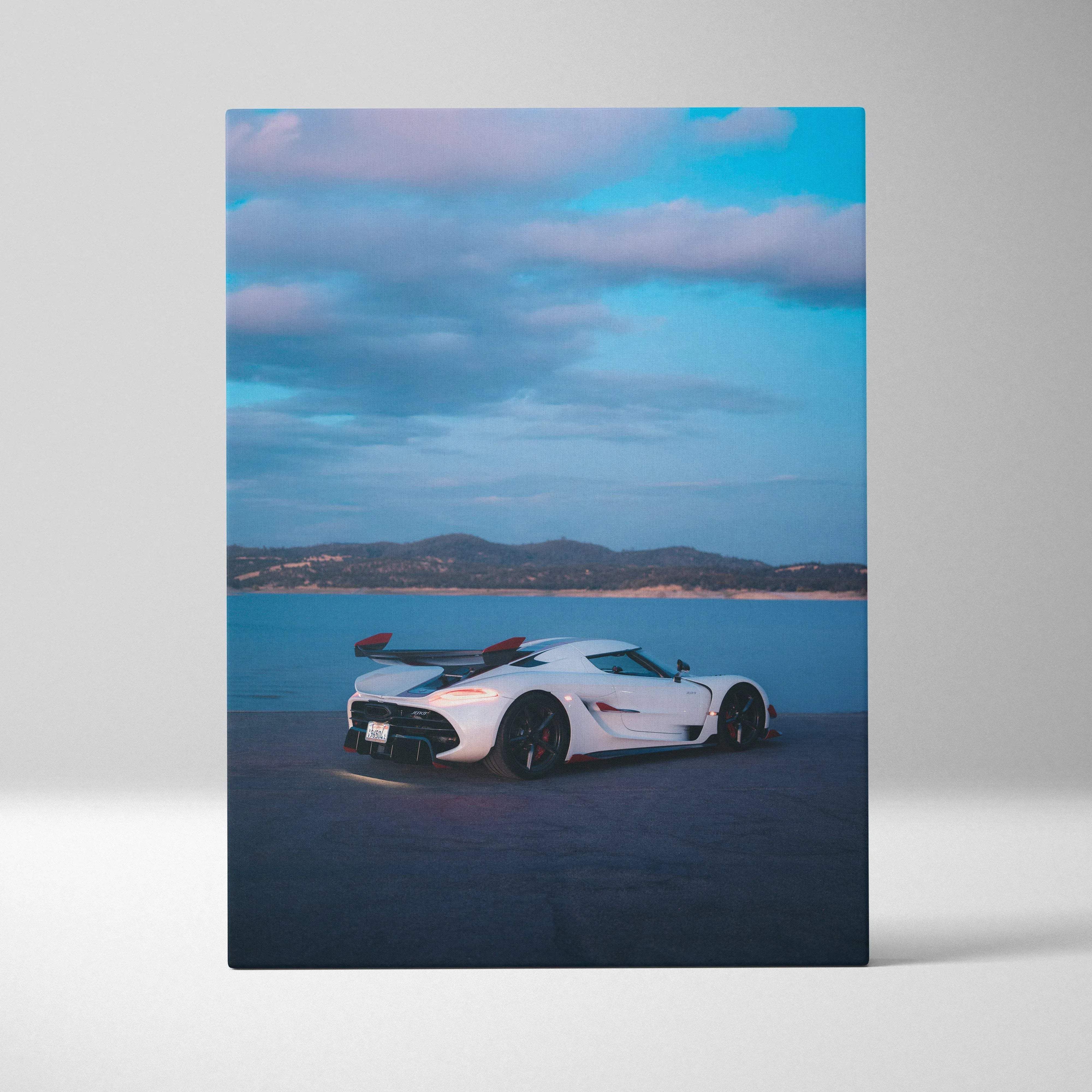 Koenigsegg Jesko vertical canvas print of white hypercar with black accents and red-tipped rear wing coastal twilight background