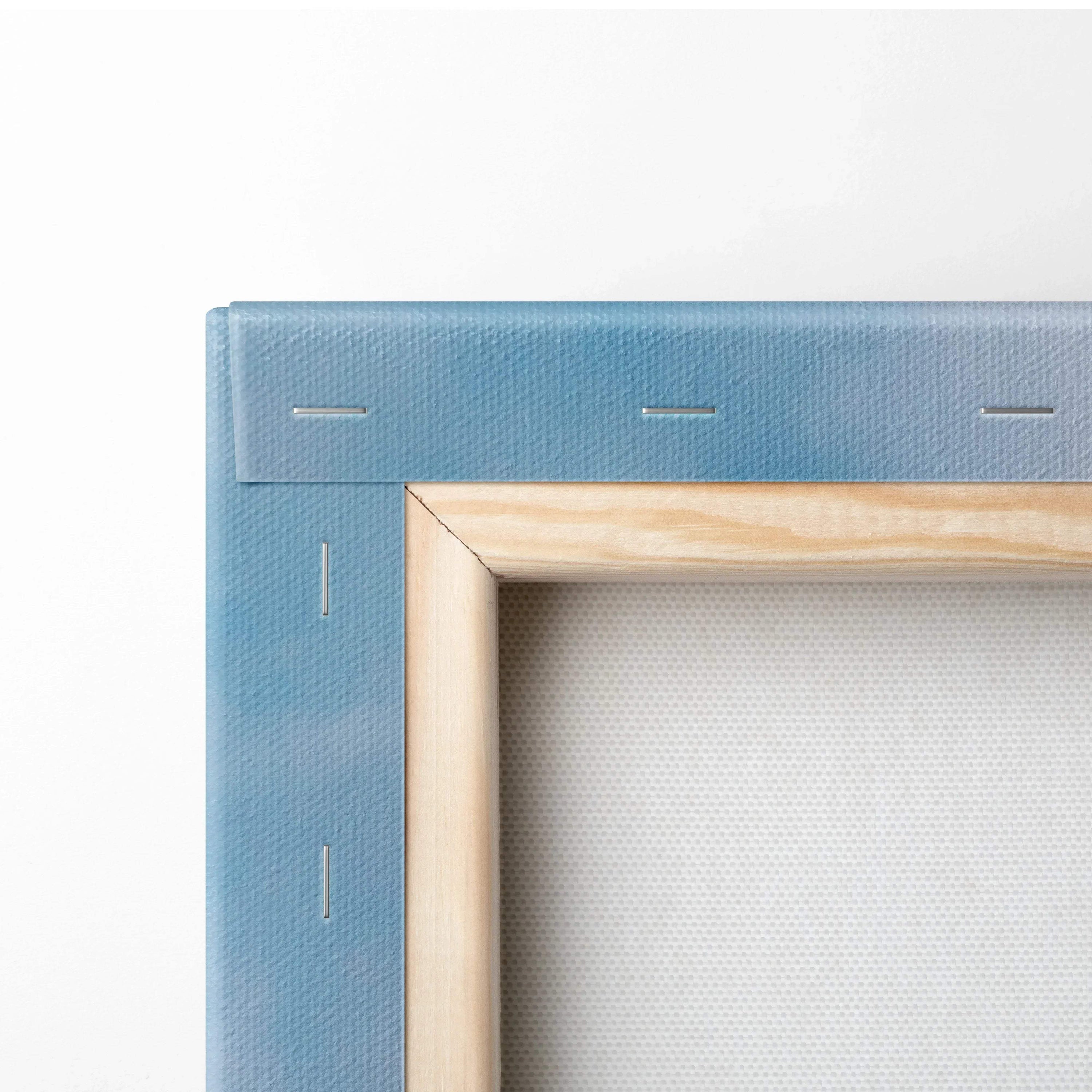 Close-up of wooden frame corner with blue canvas stretched over staples for wall art canvas print.