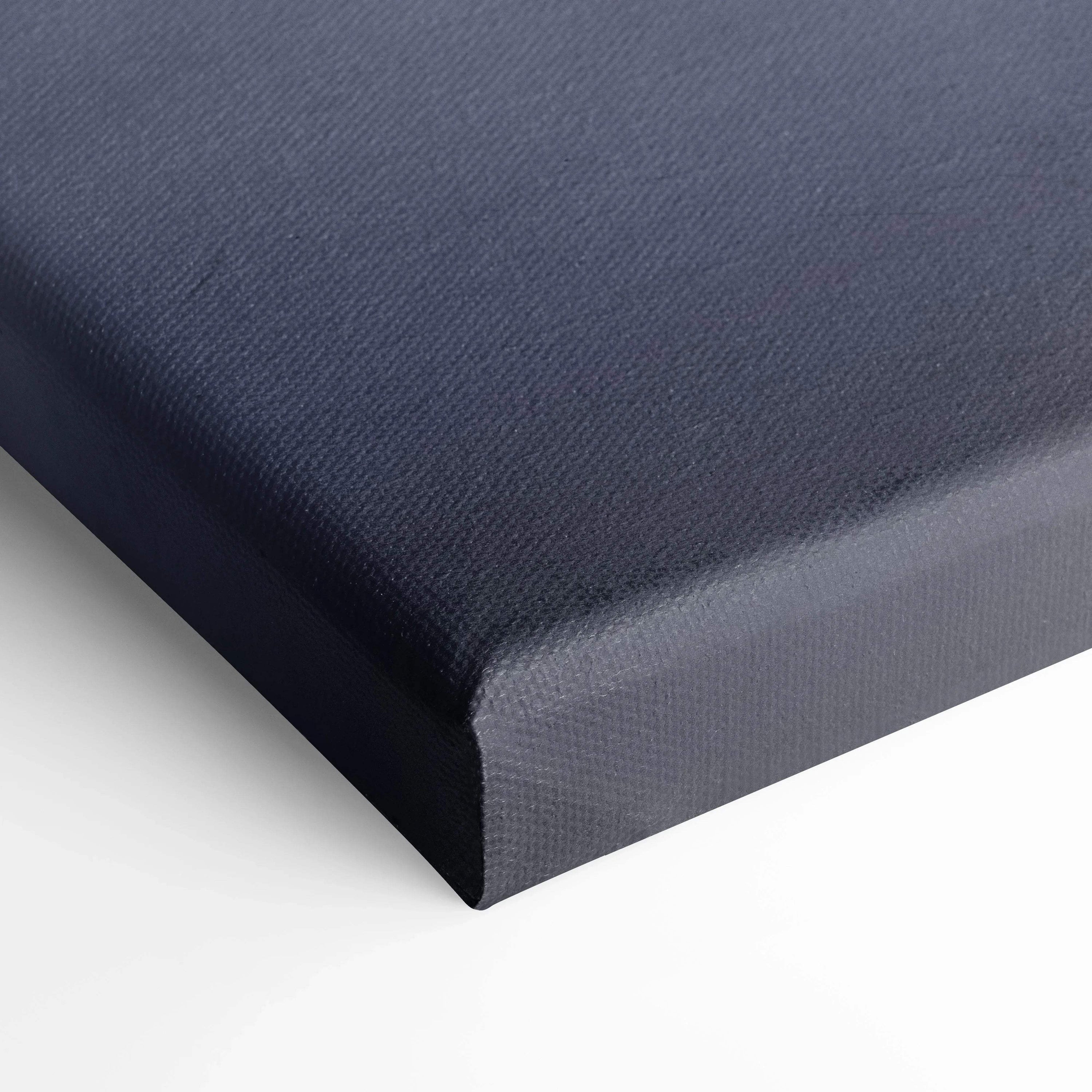 Close-up of dark blue textured canvas wall art with tightly wrapped corners and smooth edges.