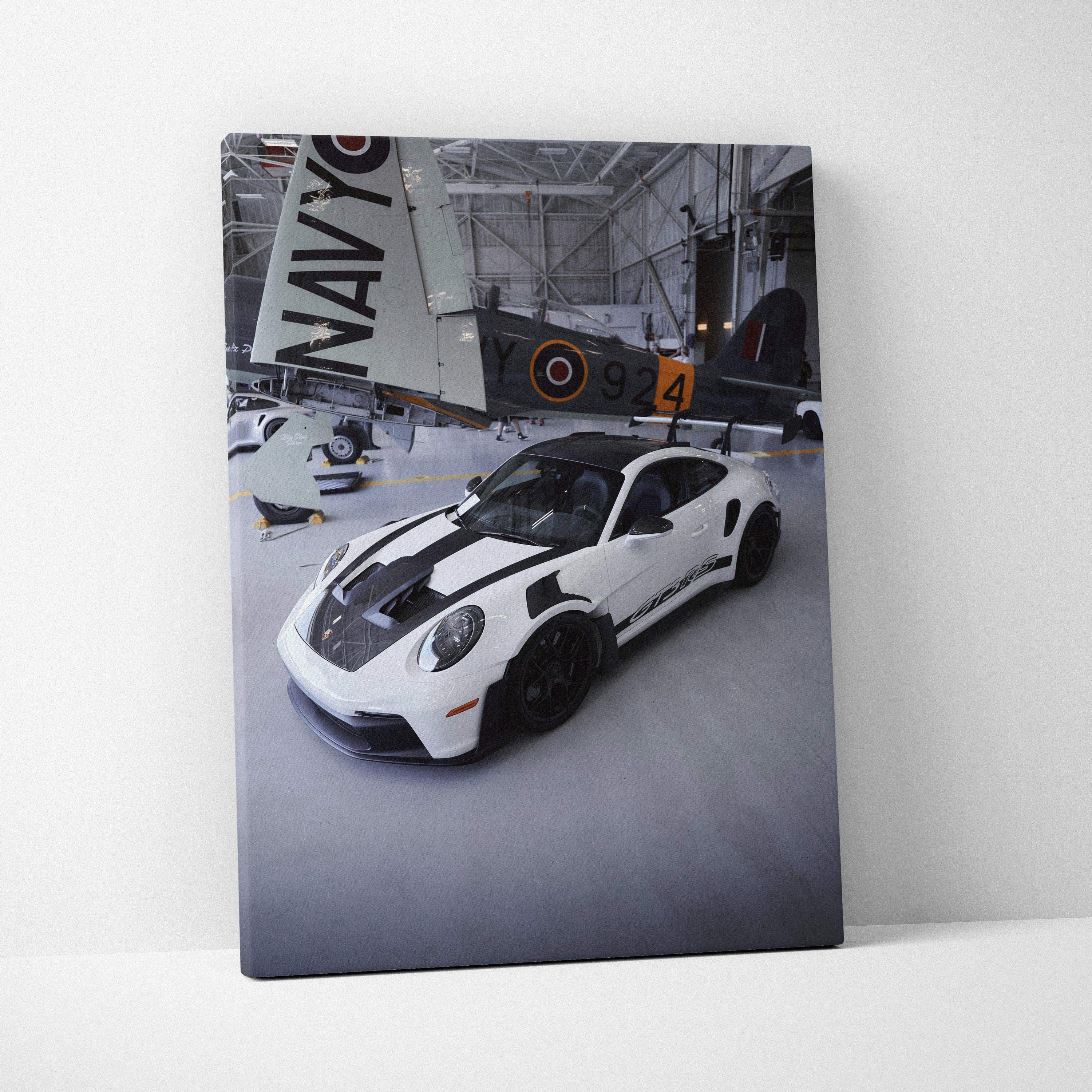White Porsche 911 GT3RS with black racing stripes canvas wall art in sleek indoor setting.