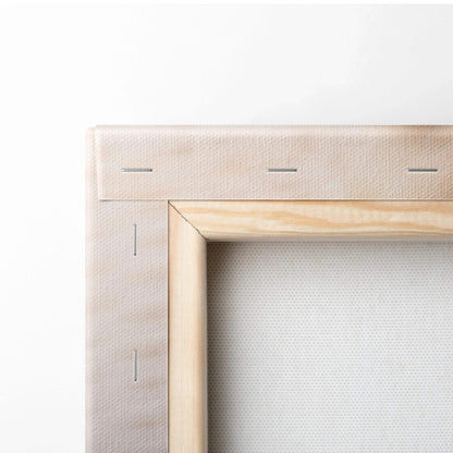 Close-up of wooden stretcher frame and stapled beige canvas fabric for wall art decor.