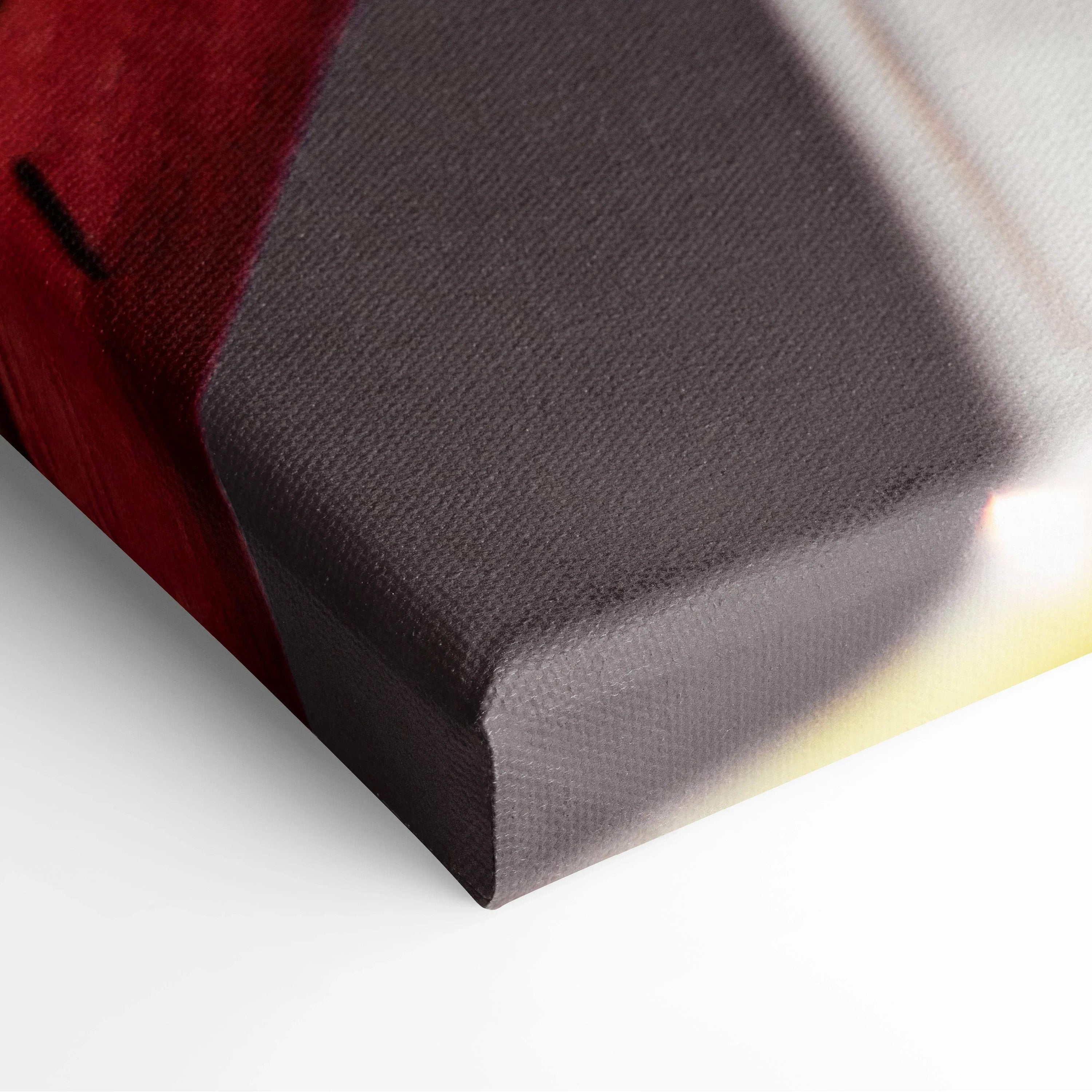 Close-up of canvas wall art corner showing textured surface with vibrant red and purple hues.