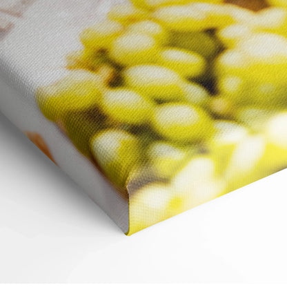 Close-up of canvas wall art showing vibrant yellow grapes on textured surface for home decor.