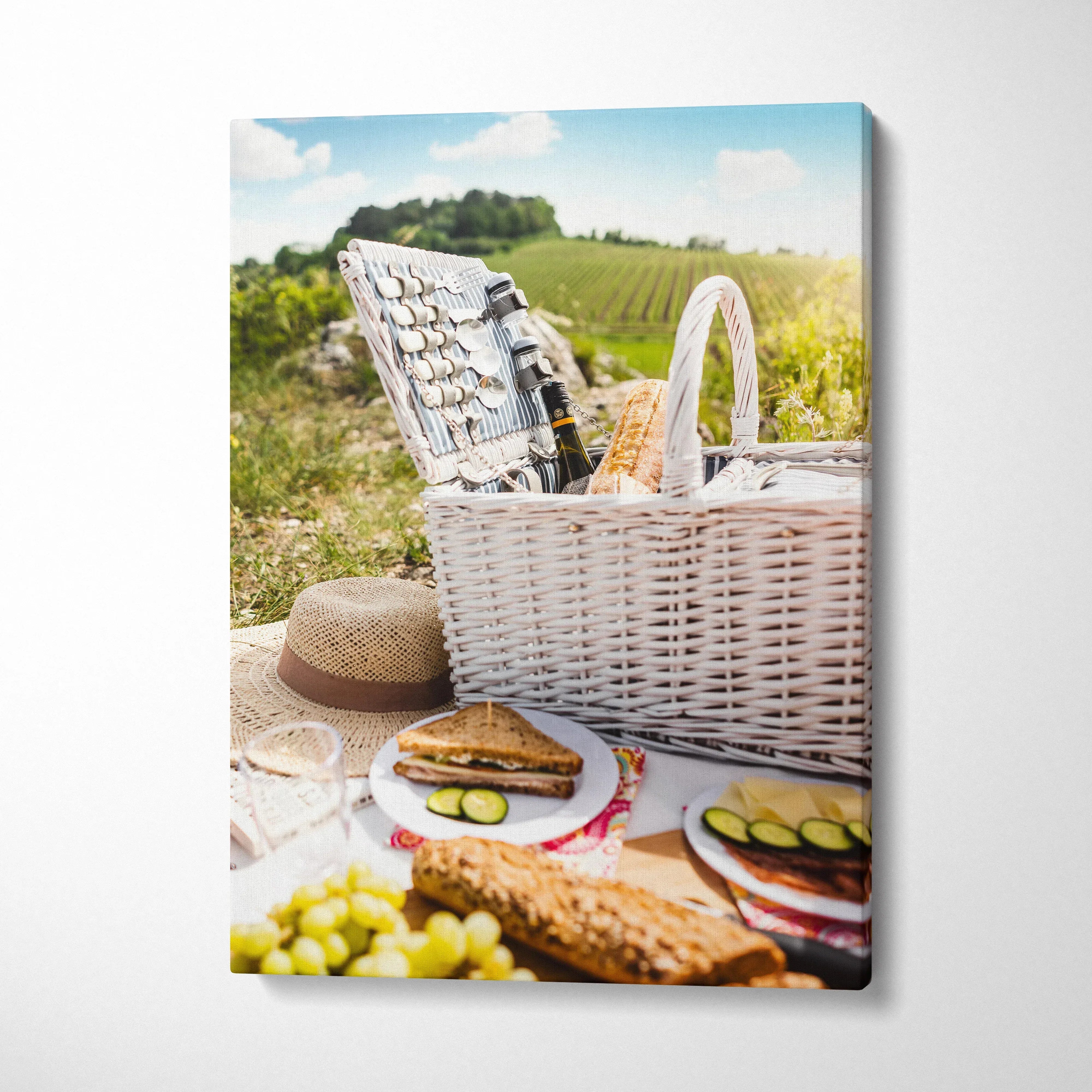 Canvas wall art featuring a vibrant outdoor picnic scene with a woven basket and food for home decor.