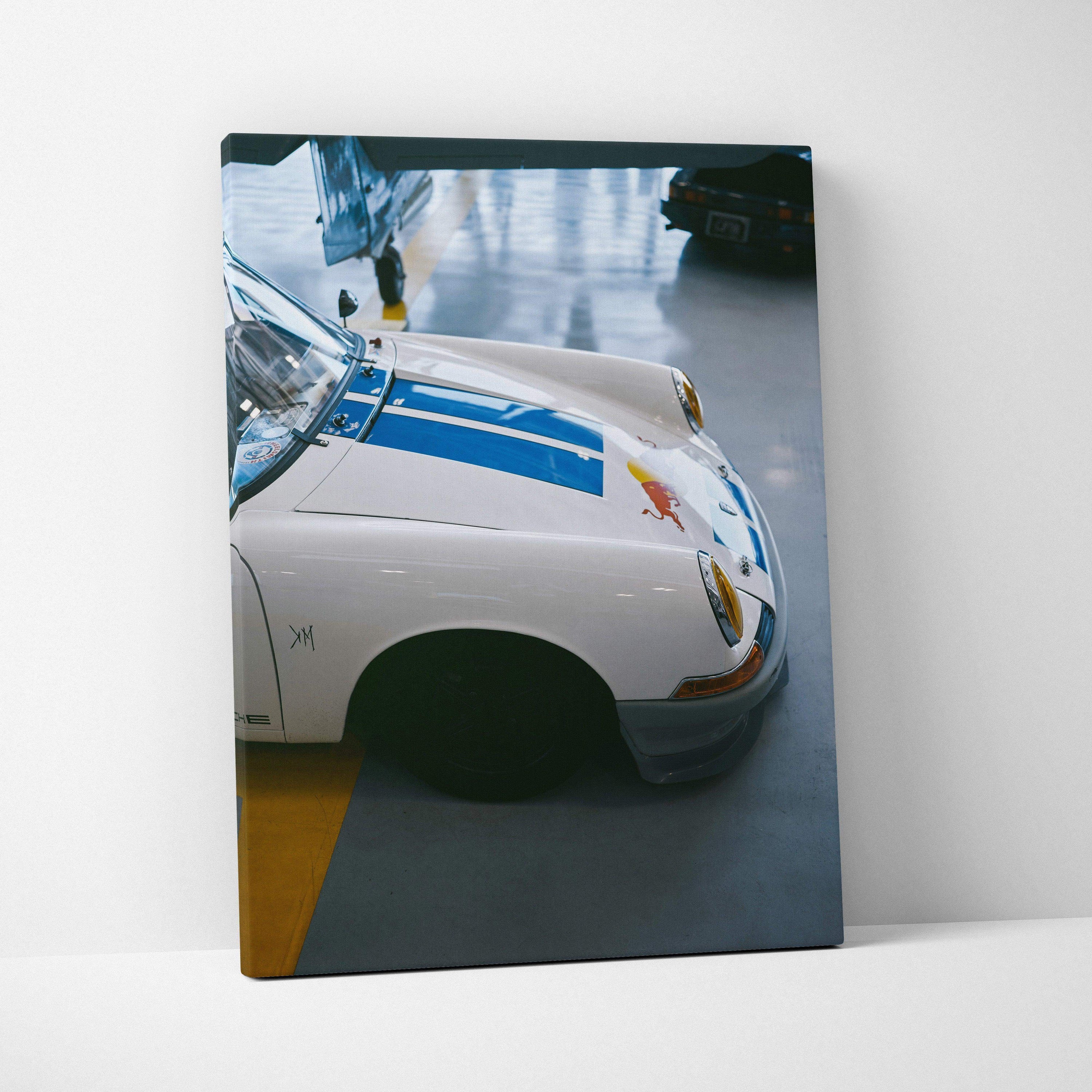 Porsche 911 classic car detailed close-up on vertical canvas wall art with blue racing stripes.
