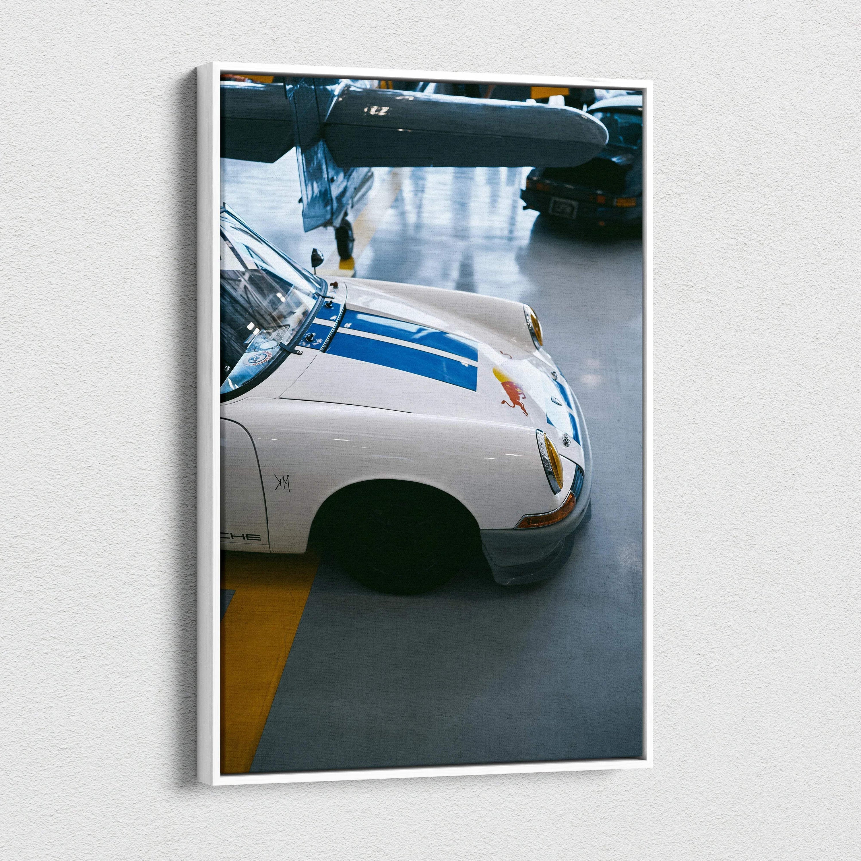Vertical canvas art of a white Porsche 911 front with blue stripes in museum-quality wall art style.