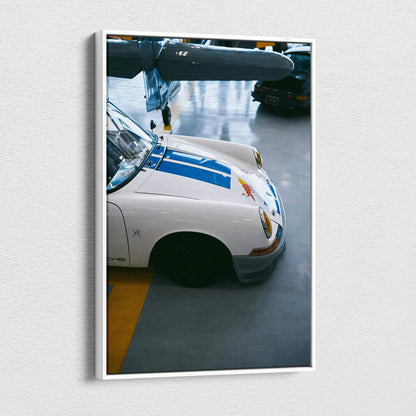Vertical canvas art of a white Porsche 911 front with blue stripes in museum-quality wall art style.