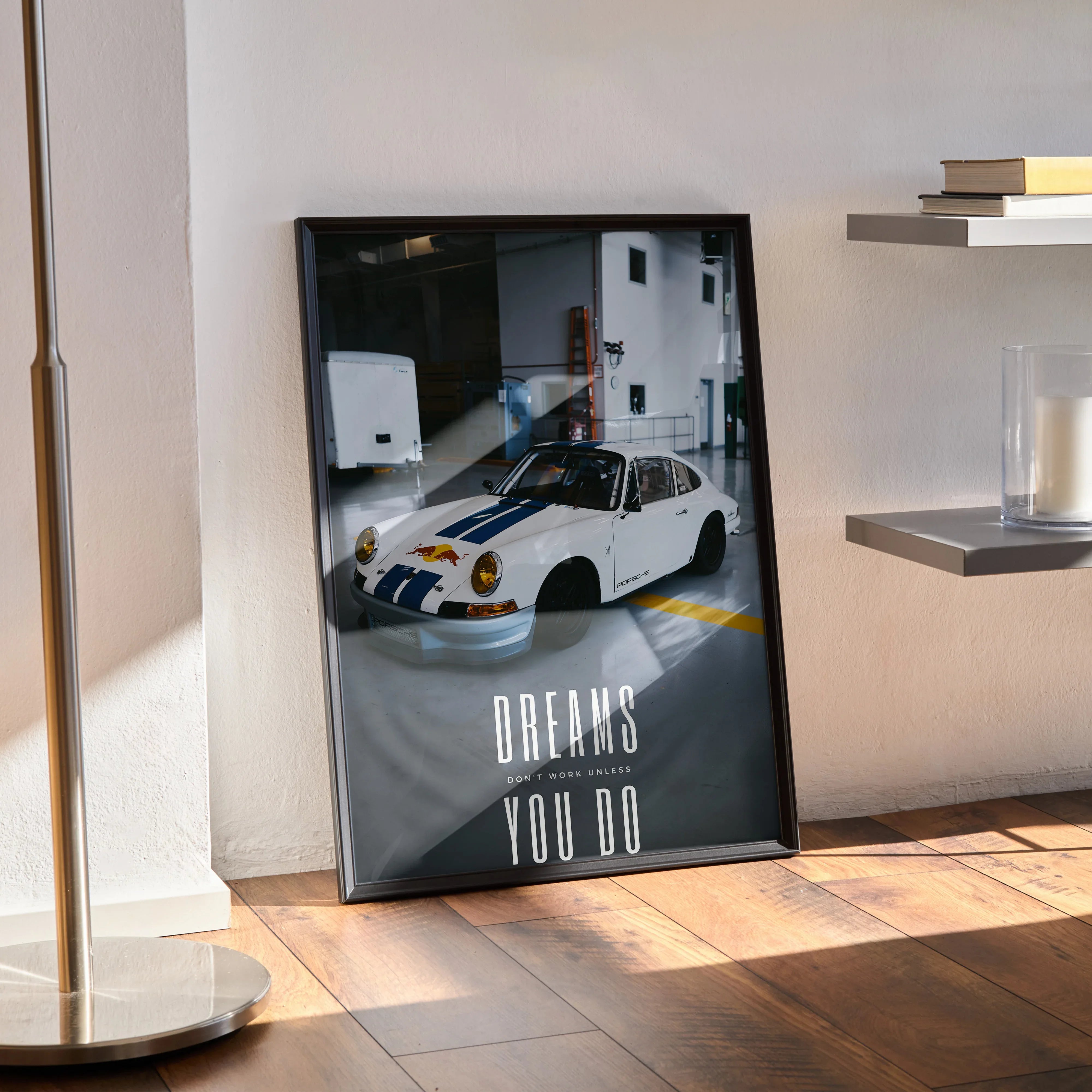 Motivational poster wall art featuring a white Porsche 911 classic car with inspiring text "Dreams You Do" in black frame.