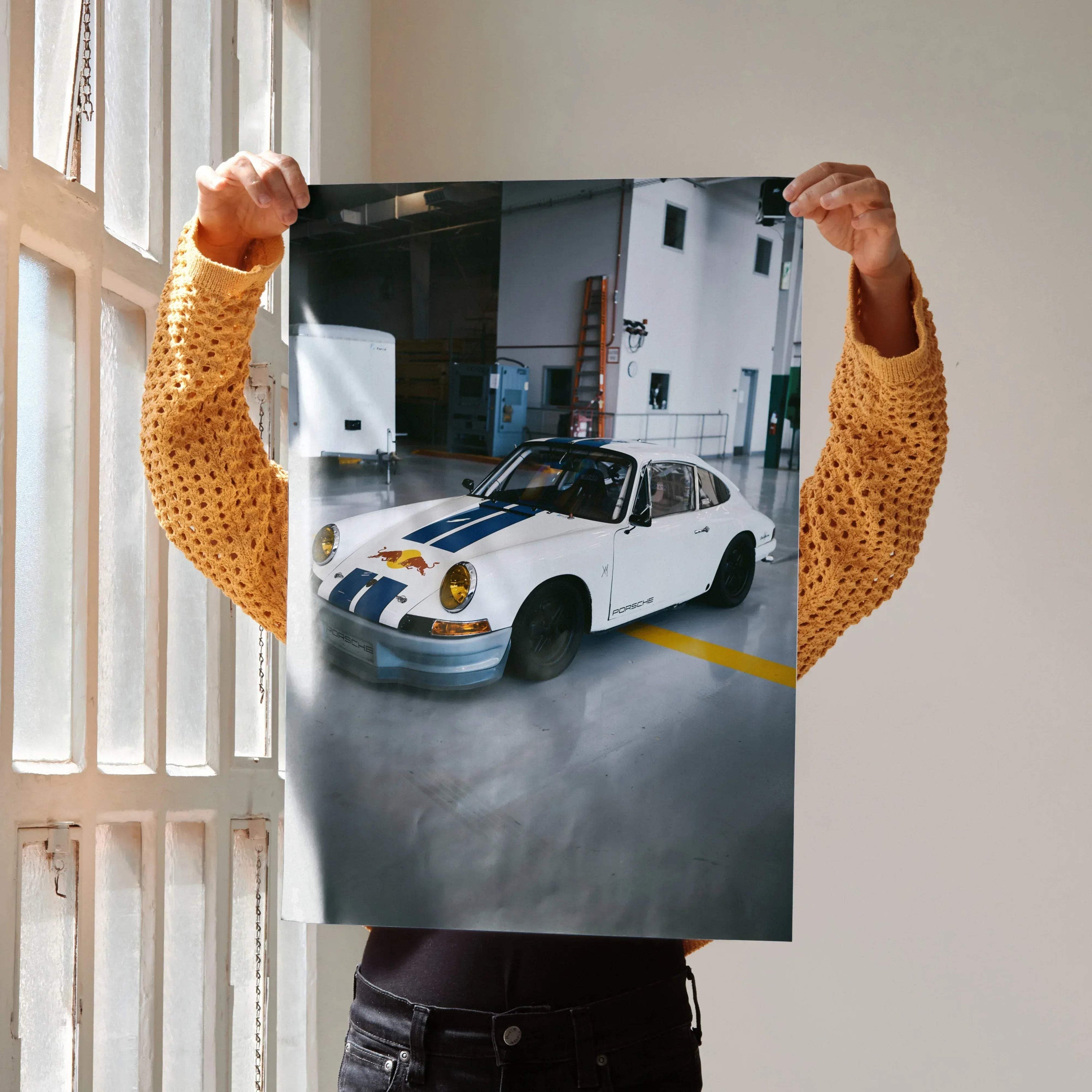 Porsche 911 classic white car poster held indoors, high-resolution wall art with urban garage background.