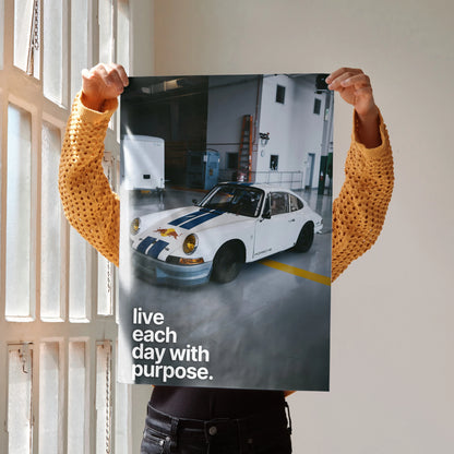 Motivational poster wall art featuring a classic white Porsche 911 in a garage with the text "live each day with purpose.".