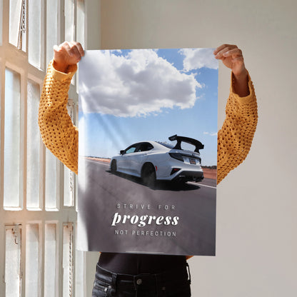 Motivational poster wall art featuring a white Subaru WRX STI on an open road under a cloudy sky with inspiring text.