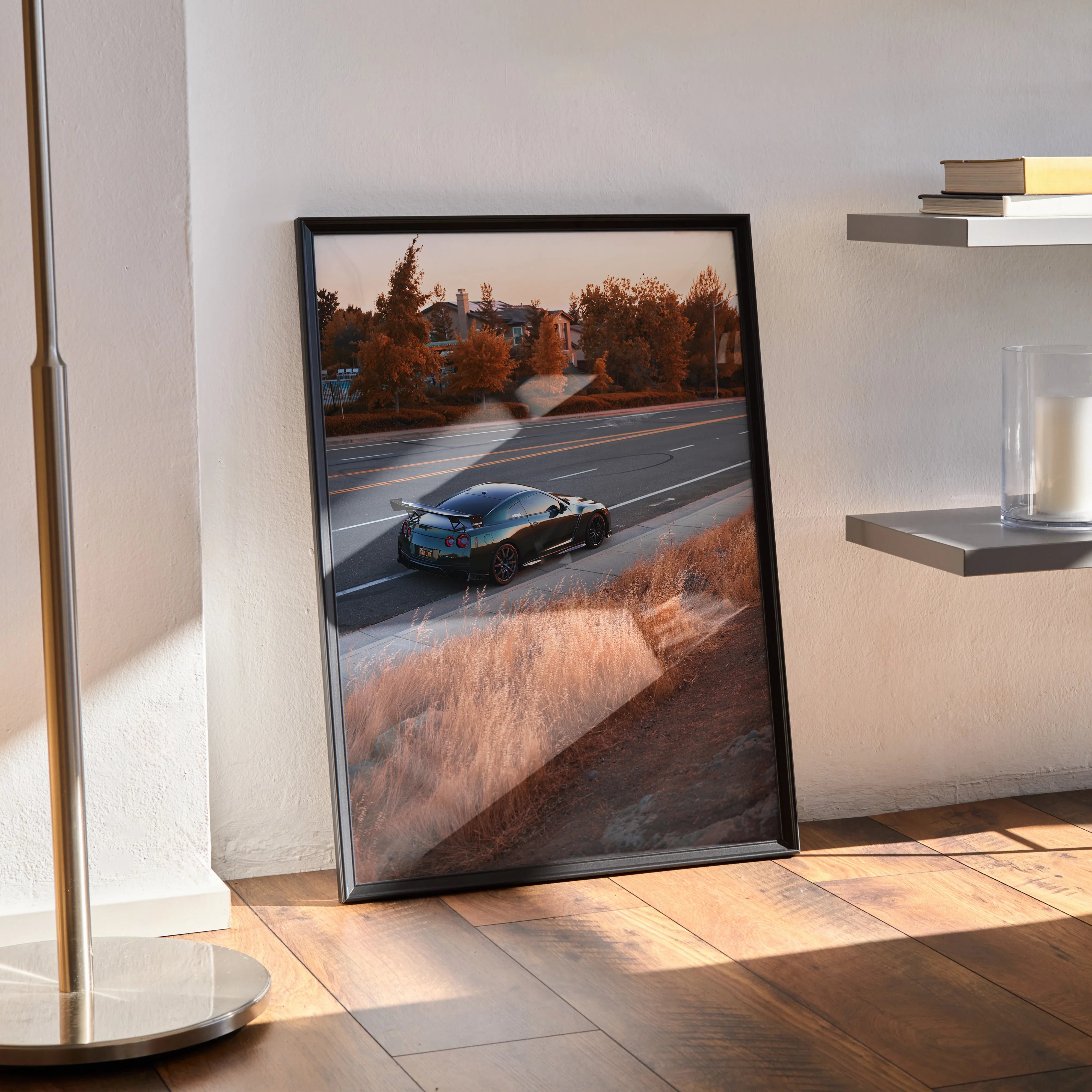 Nissan GTR R35 poster with sunset tones and dynamic road scene, high-resolution wall art in black frame.