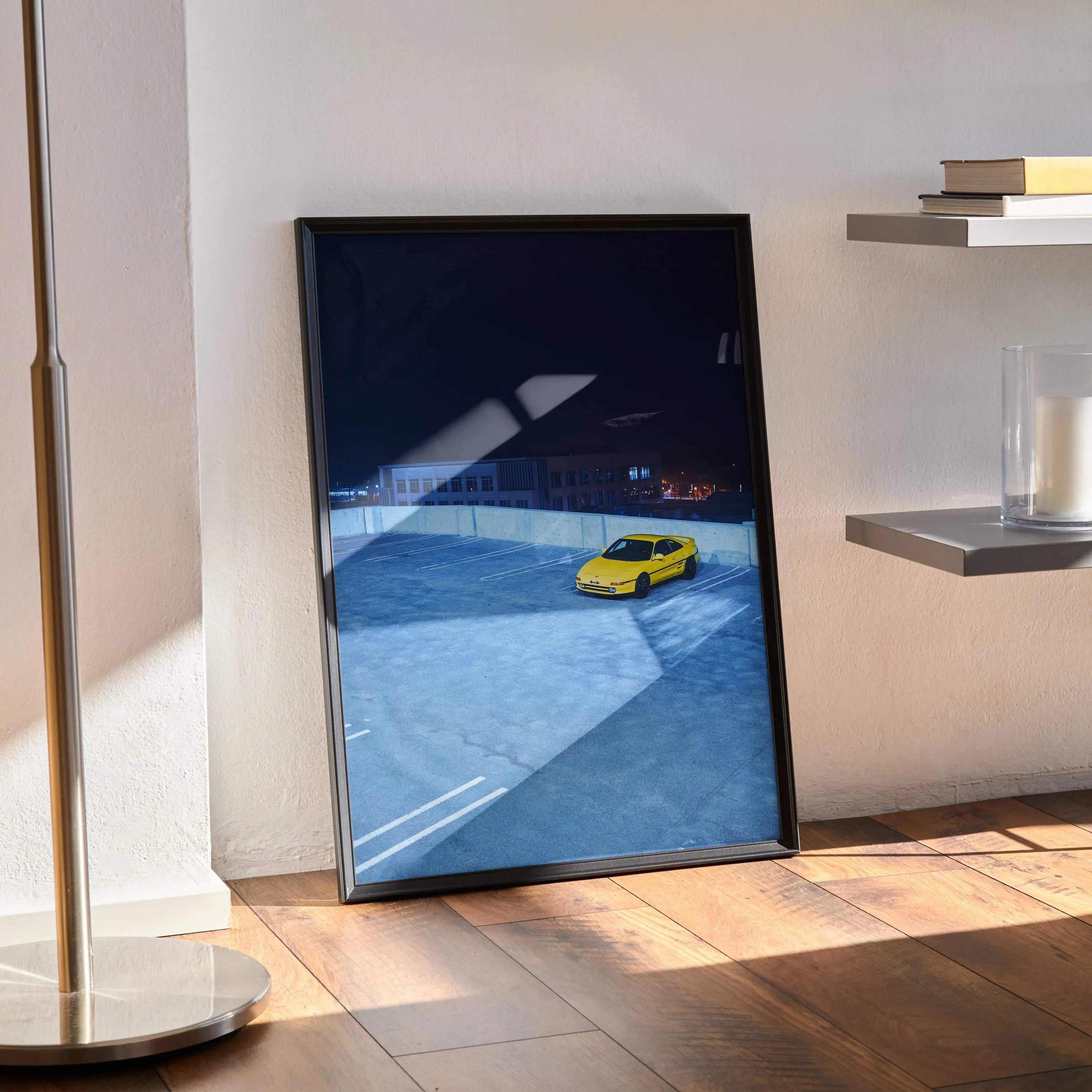 Toyota MR2 poster wall art featuring a yellow sports car on a blue racetrack backdrop.