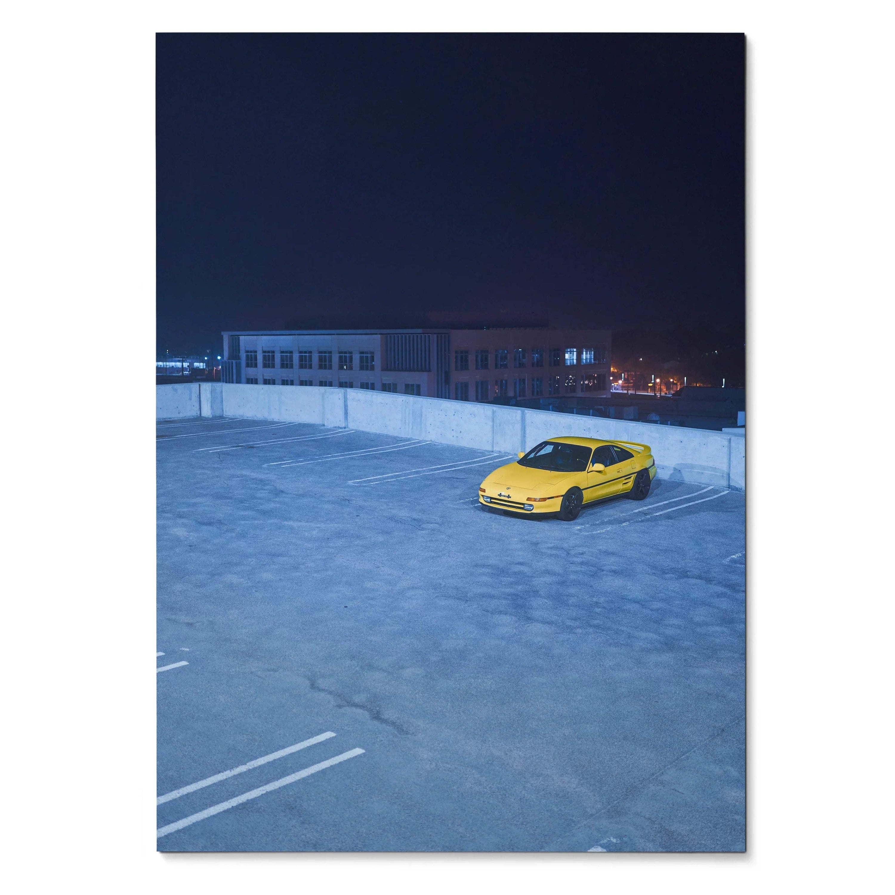 Yellow Toyota MR2 parked alone on rooftop at night poster wall art.