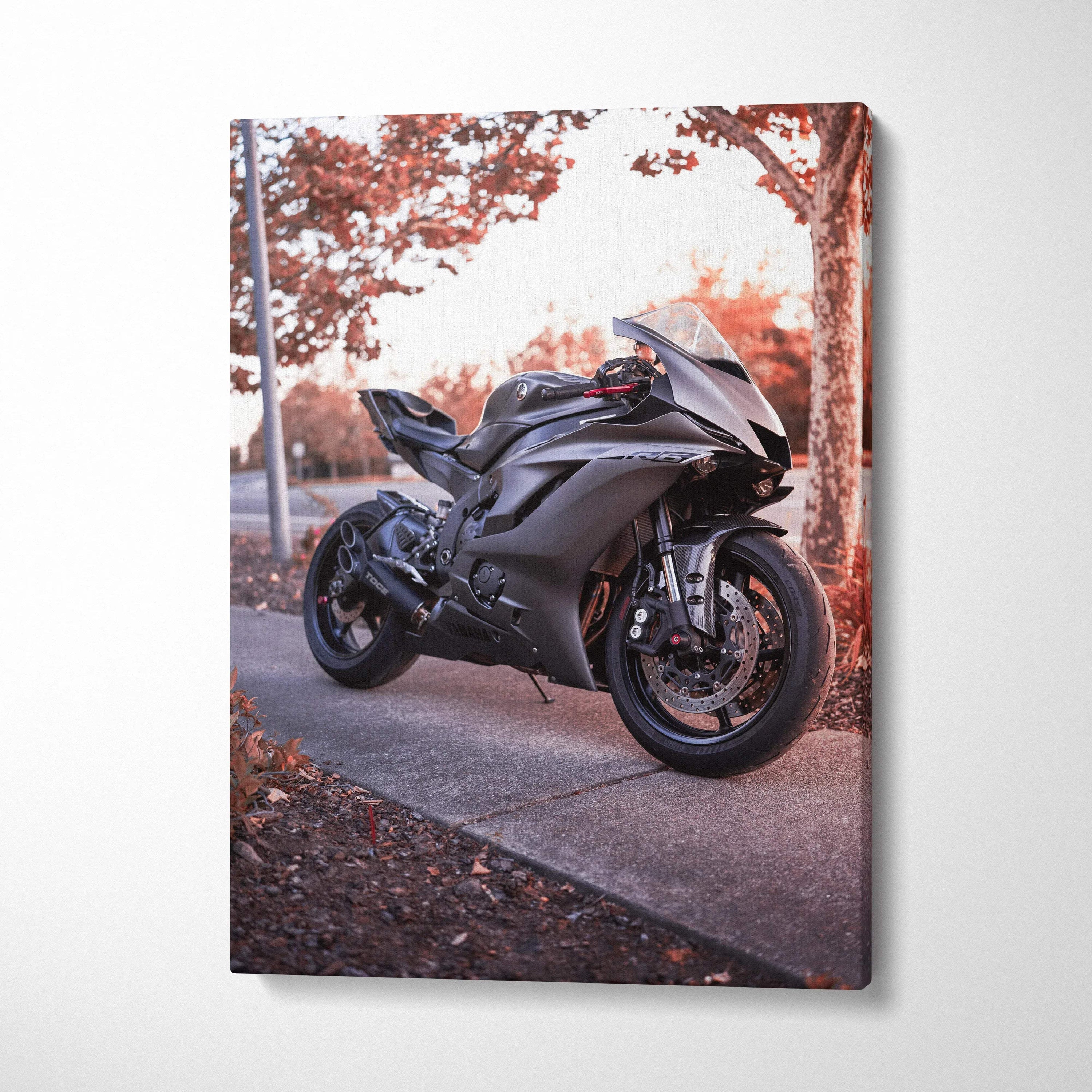 Black Yamaha R6 motorcycle on sidewalk with autumn trees canvas wall art.