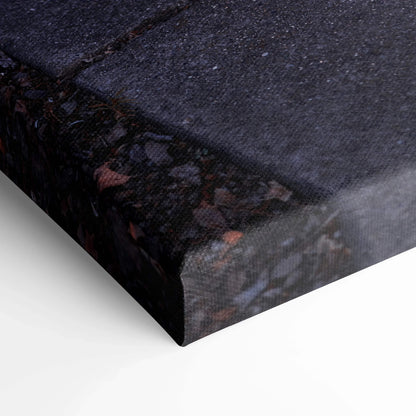 Close-up of textured black canvas art corner with subtle dark abstract design, vertical wall art print.