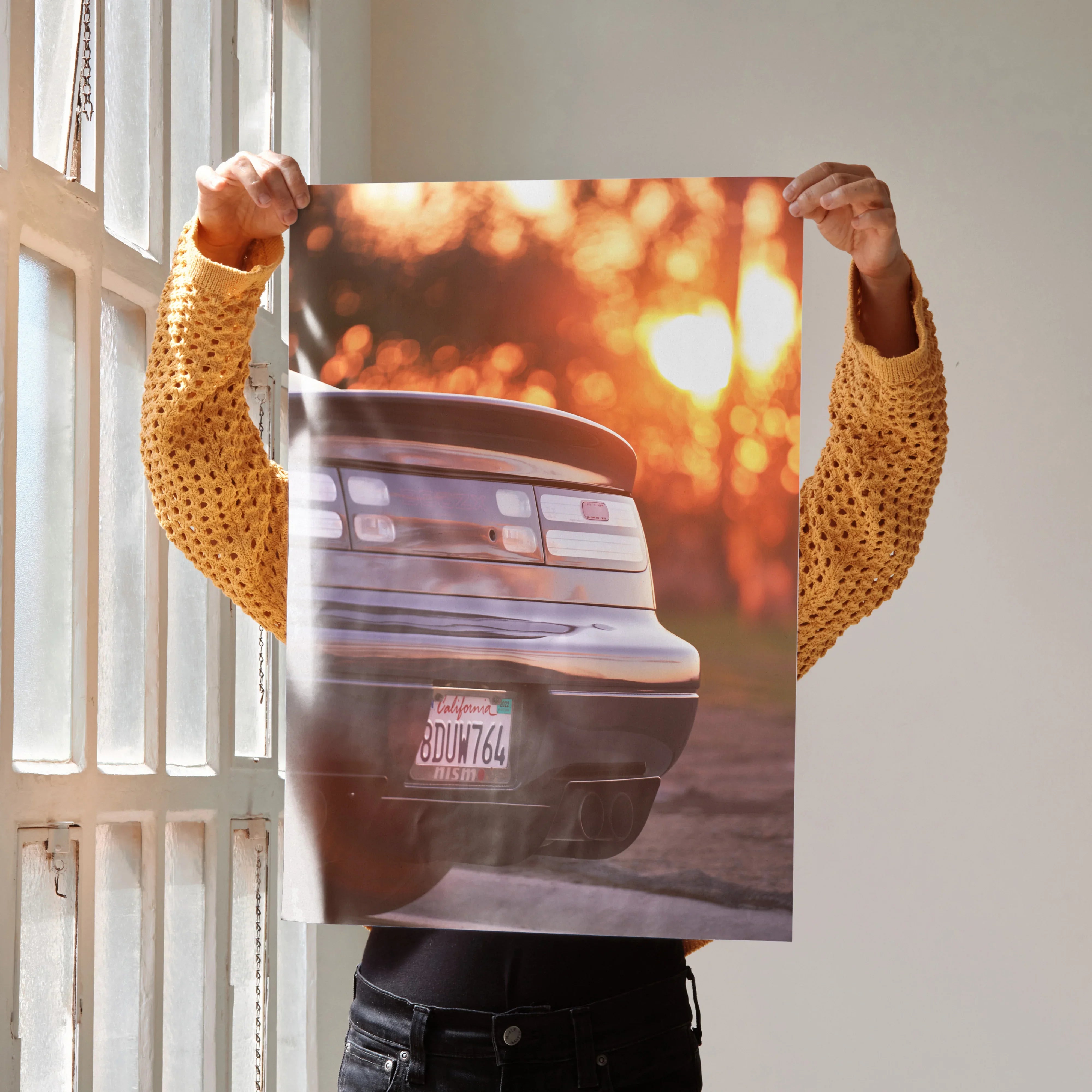 Nissan 300ZX poster showing rear view of car at sunset with warm orange bokeh background wall art.