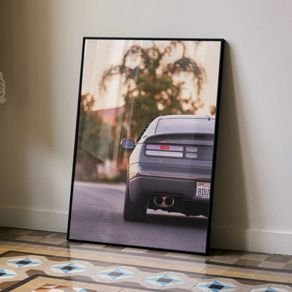 Nissan 300ZX rear view poster wall art with blurred natural background in black frame.