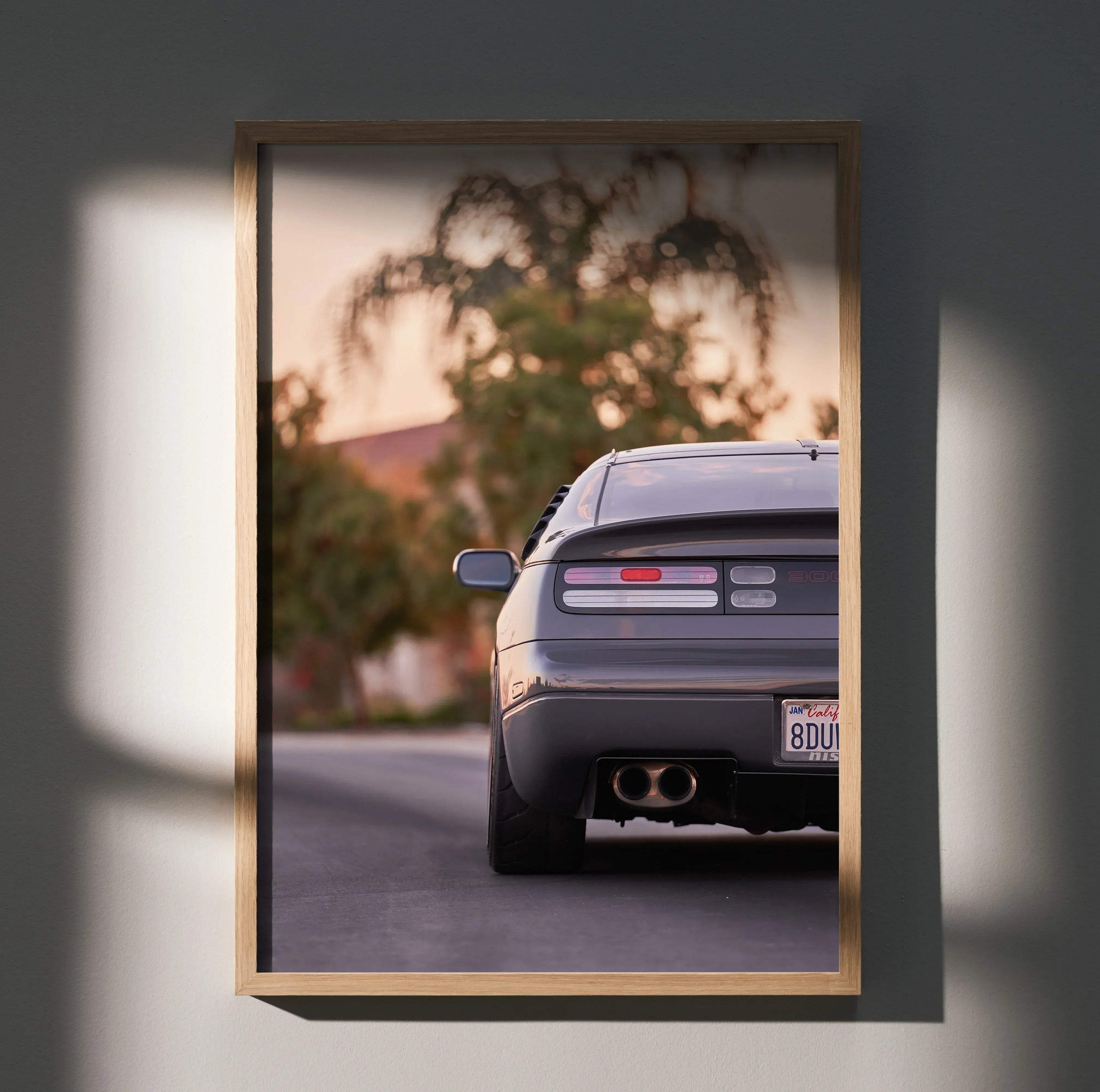 Nissan 300ZX rear view poster framed as wall art with warm sunset background and tree silhouette.