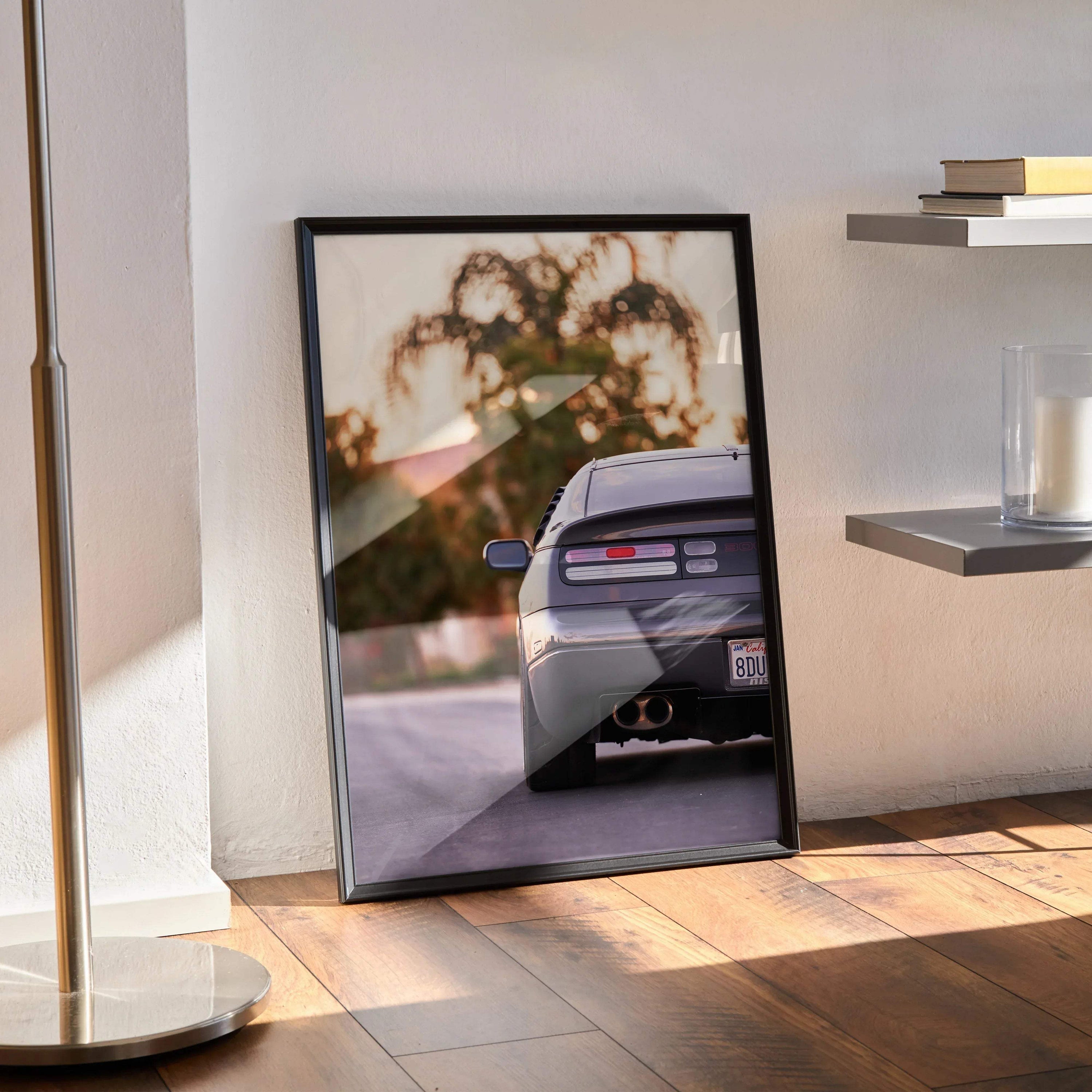 Nissan 300ZX rear view poster wall art with sunset and blurred trees in black frame.