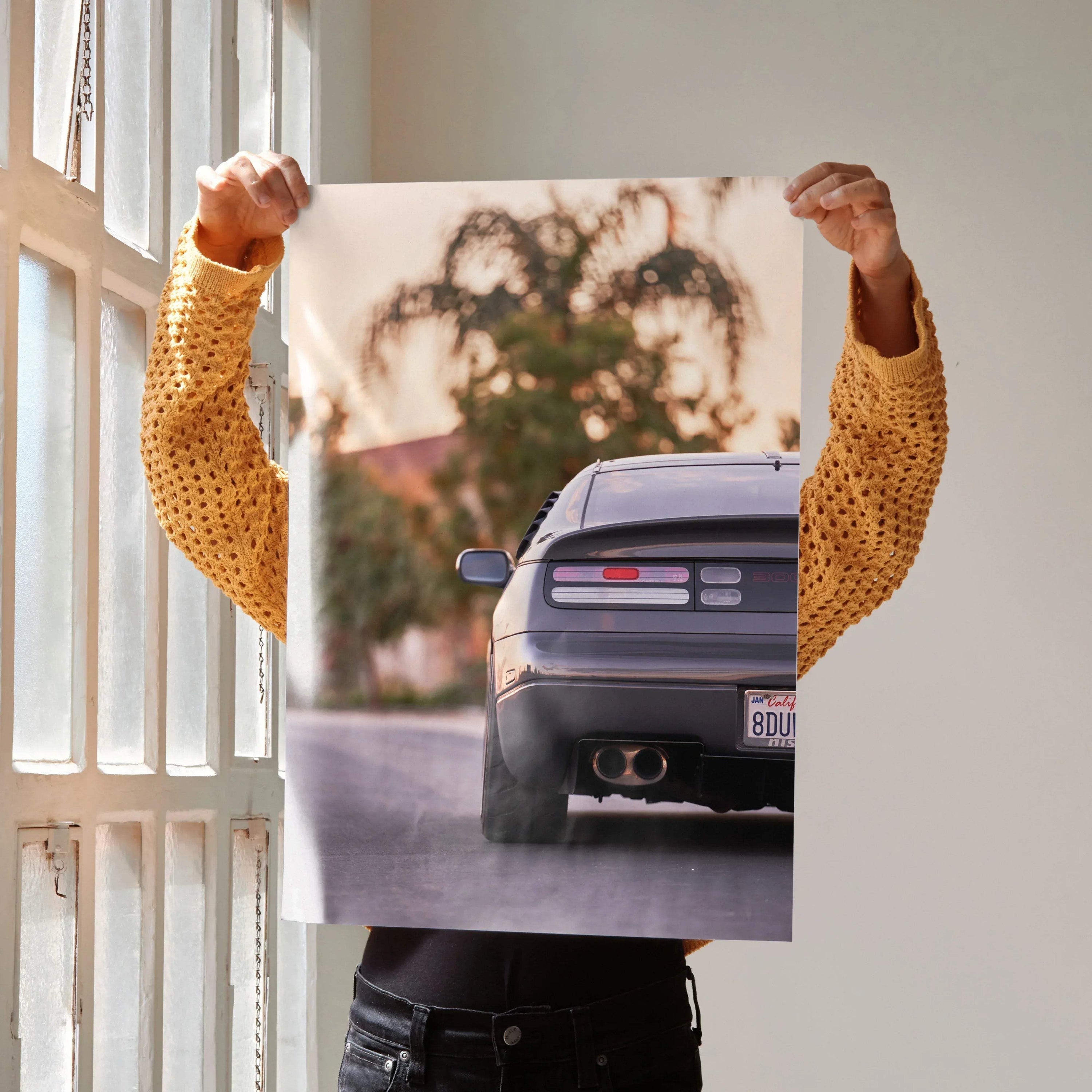 Nissan 300ZX rear view art print held up near window, automotive poster wall art.