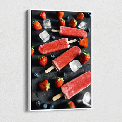 Canvas wall art featuring vibrant red strawberry popsicles with fresh strawberries, blueberries, and ice cubes on a dark.