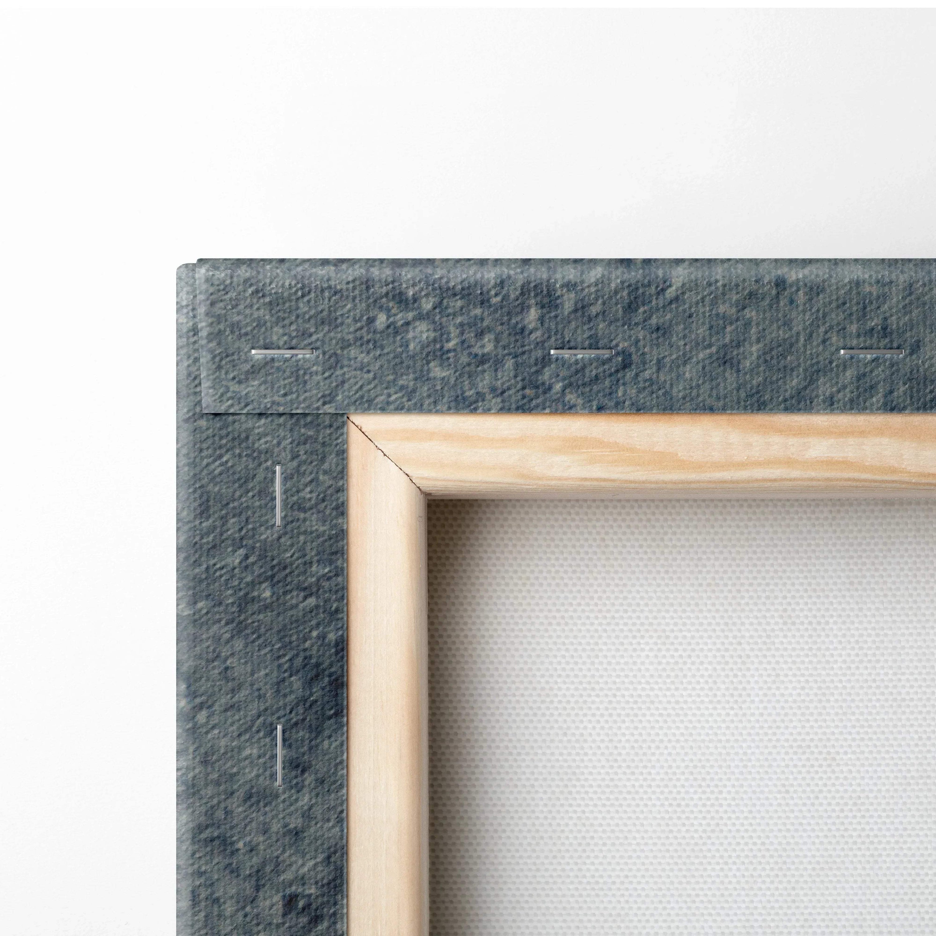 Close-up of wooden frame and stapled gray canvas backing on wall art panel.